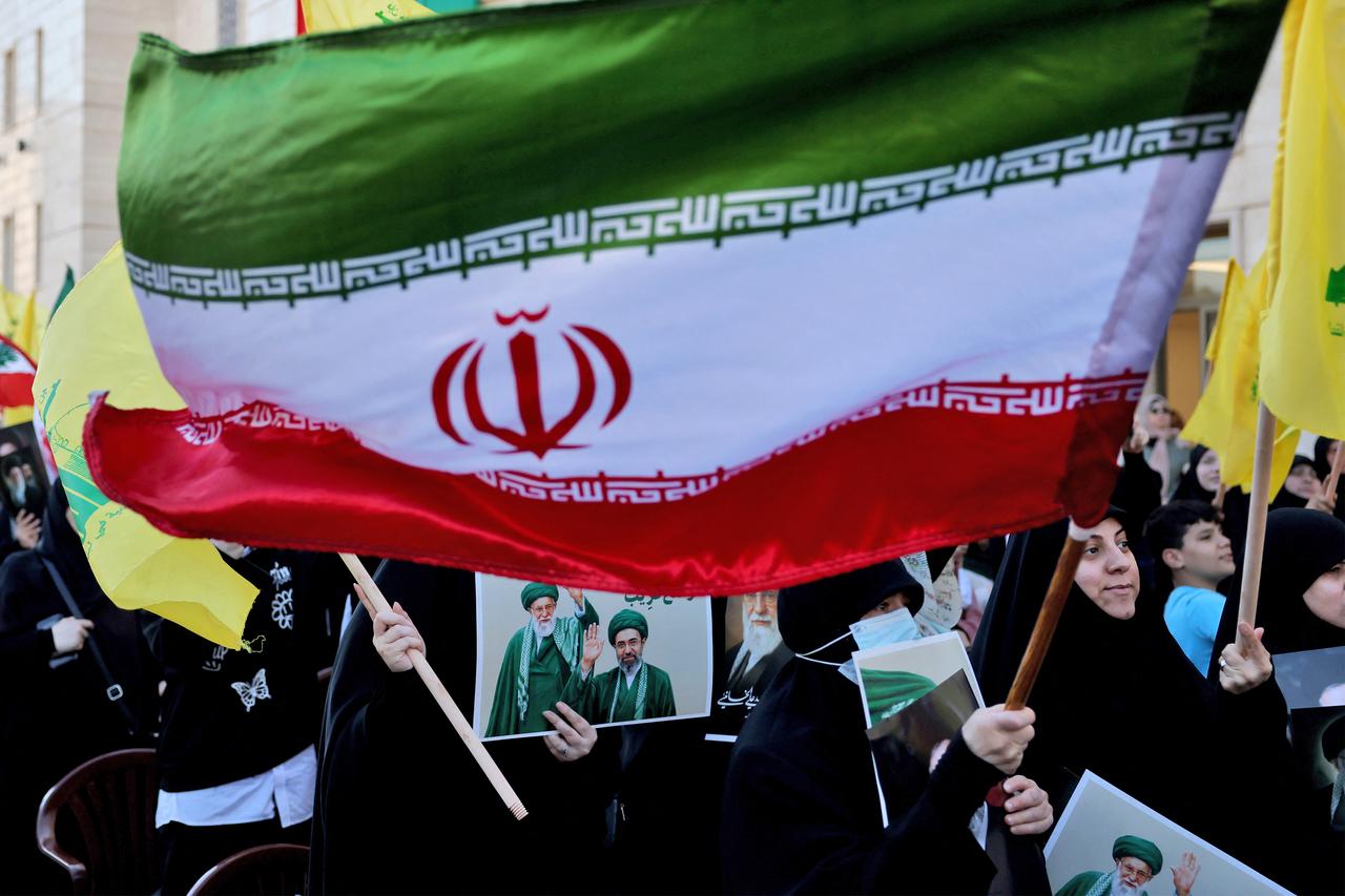 People carry Hezbollah, Iranian, and Lebanese flags, and portraits during a memorial ceremony for Iran's slain supreme leader, Ali Khamenei, at the Iranian Embassy in Beirut, April 22, 2026. (AFP Photo)