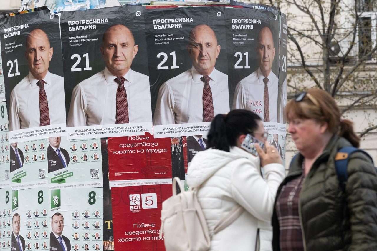 Pedestrians walk past election posters of the Progressive Bulgaria coalition's leader and former President Rumen Radev in Sofia on April 20, 2026. (AFP Photo)