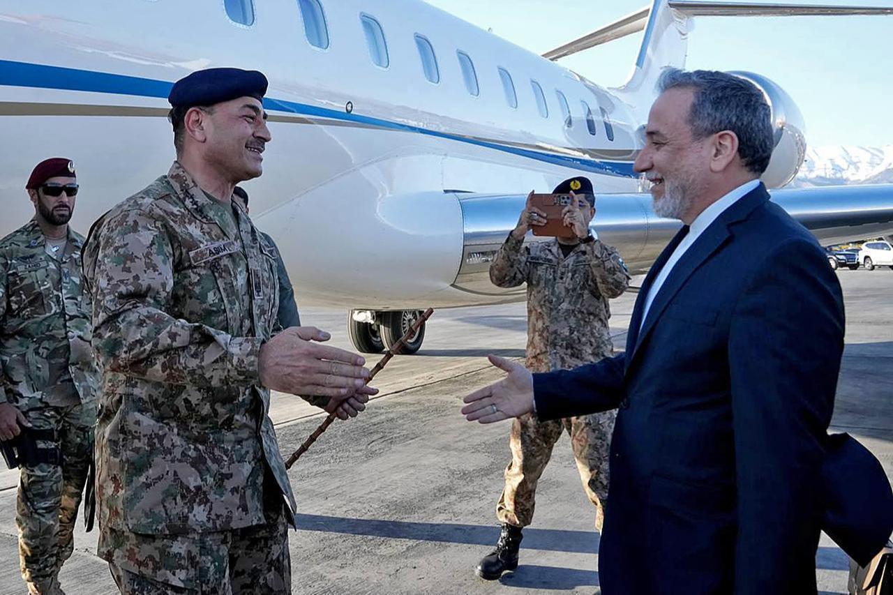 This handout photo taken on April 15, 2026 shows Iran's Foreign Minister Abbas Araghchi (R) welcoming Pakistan's Army Chief Asim Munir upon his arrival at the airport in Tehran, Iran. (Photo by Iranian Foreign Ministry / AFP)