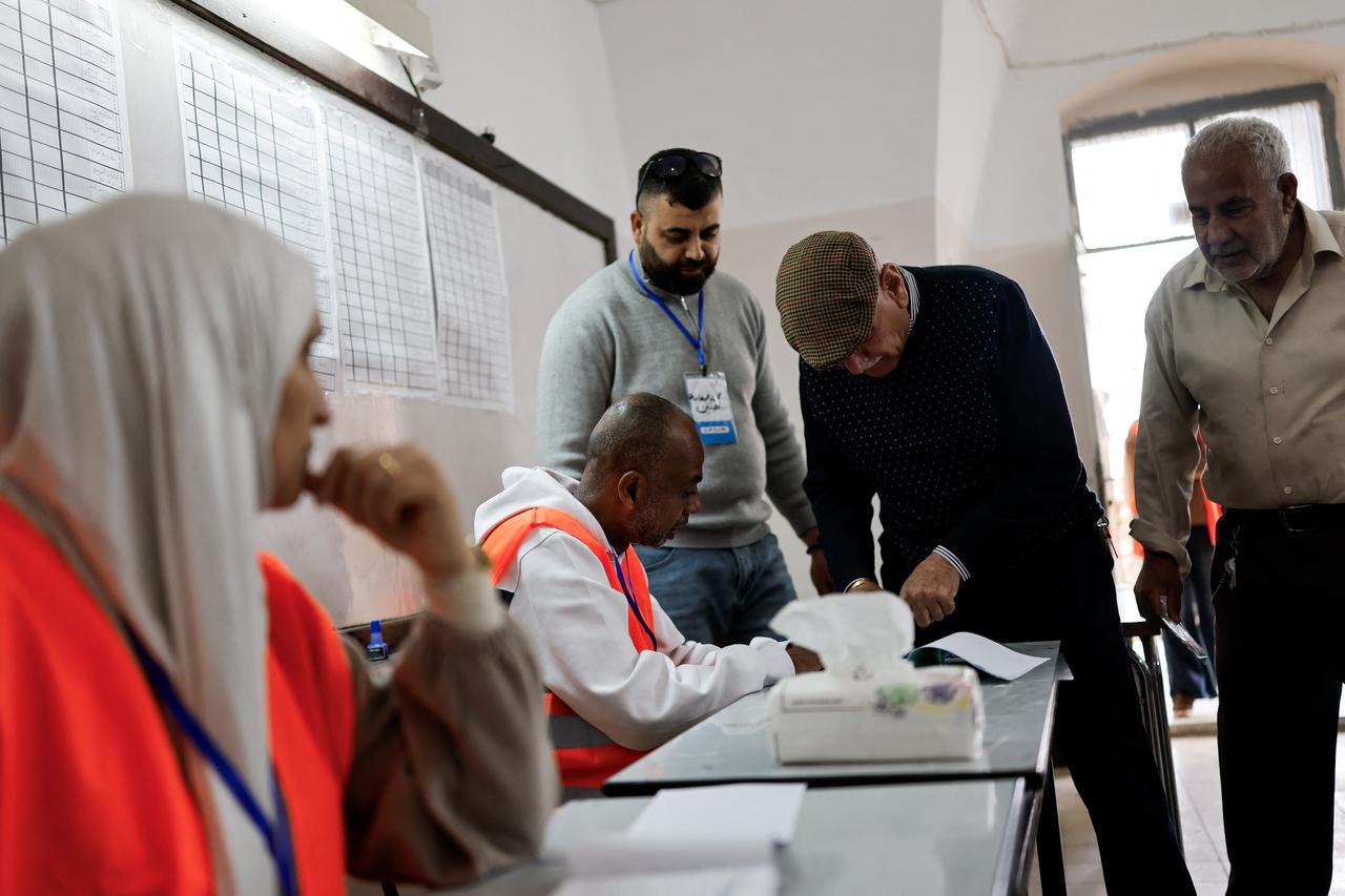 Palestinian electoral officials register voters before casting their ballots during municipal elections in the Israeli-occupied West Bank city of Jenin on April 25, 2026. (AFP Photo)