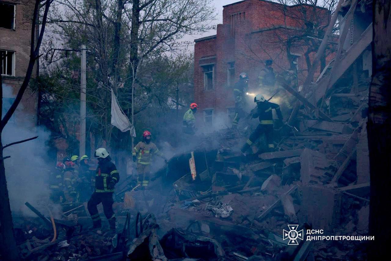 This handout photograph released by the State Emergency Service of Ukraine on April 25, 2026 shows Ukrainian rescuers clearing debris in a residential building following a Russian attack in Dnipro. (AFP Photo)