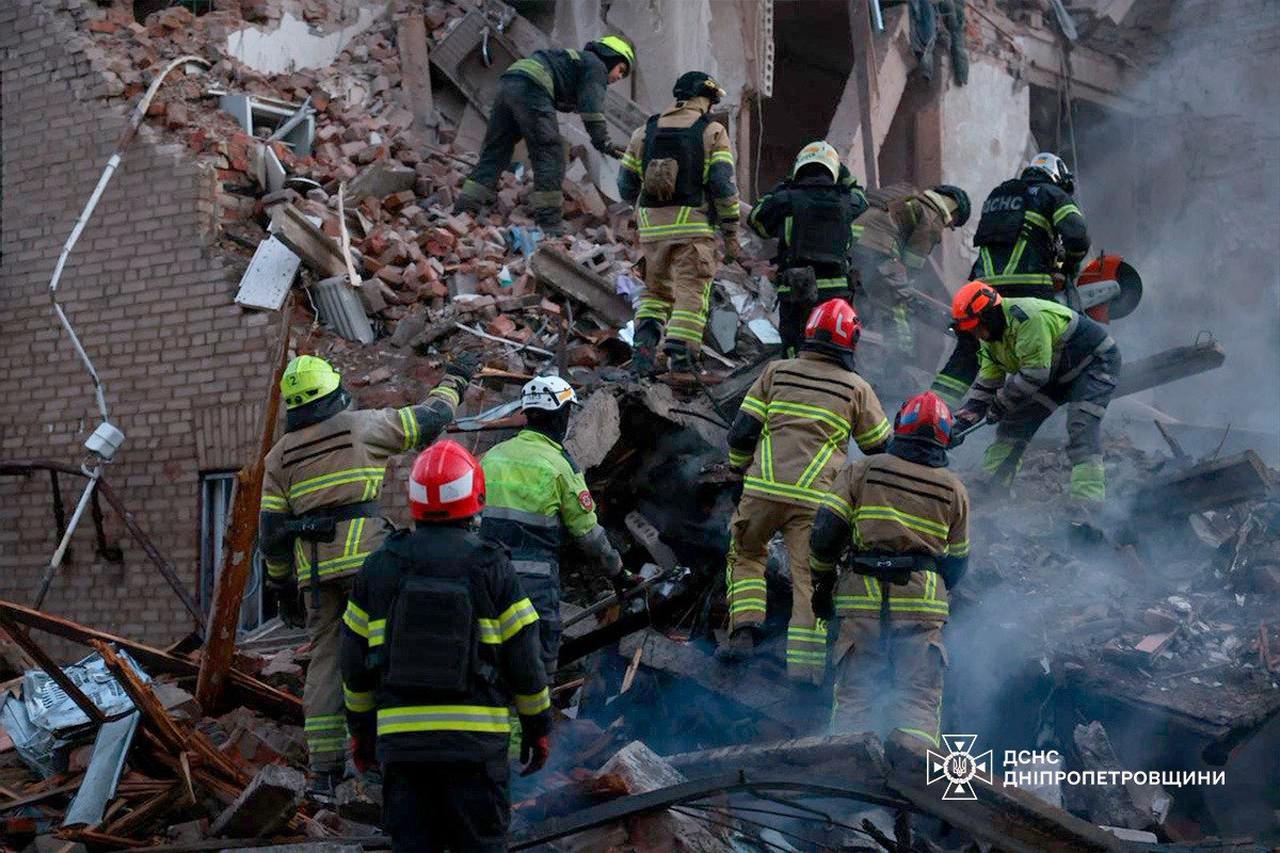 This handout photograph released by the State Emergency Service of Ukraine on April 25, 2026 shows Ukrainian rescuers clearing debris in a residential building following a Russian attack in Dnipro. (AFP Photo)