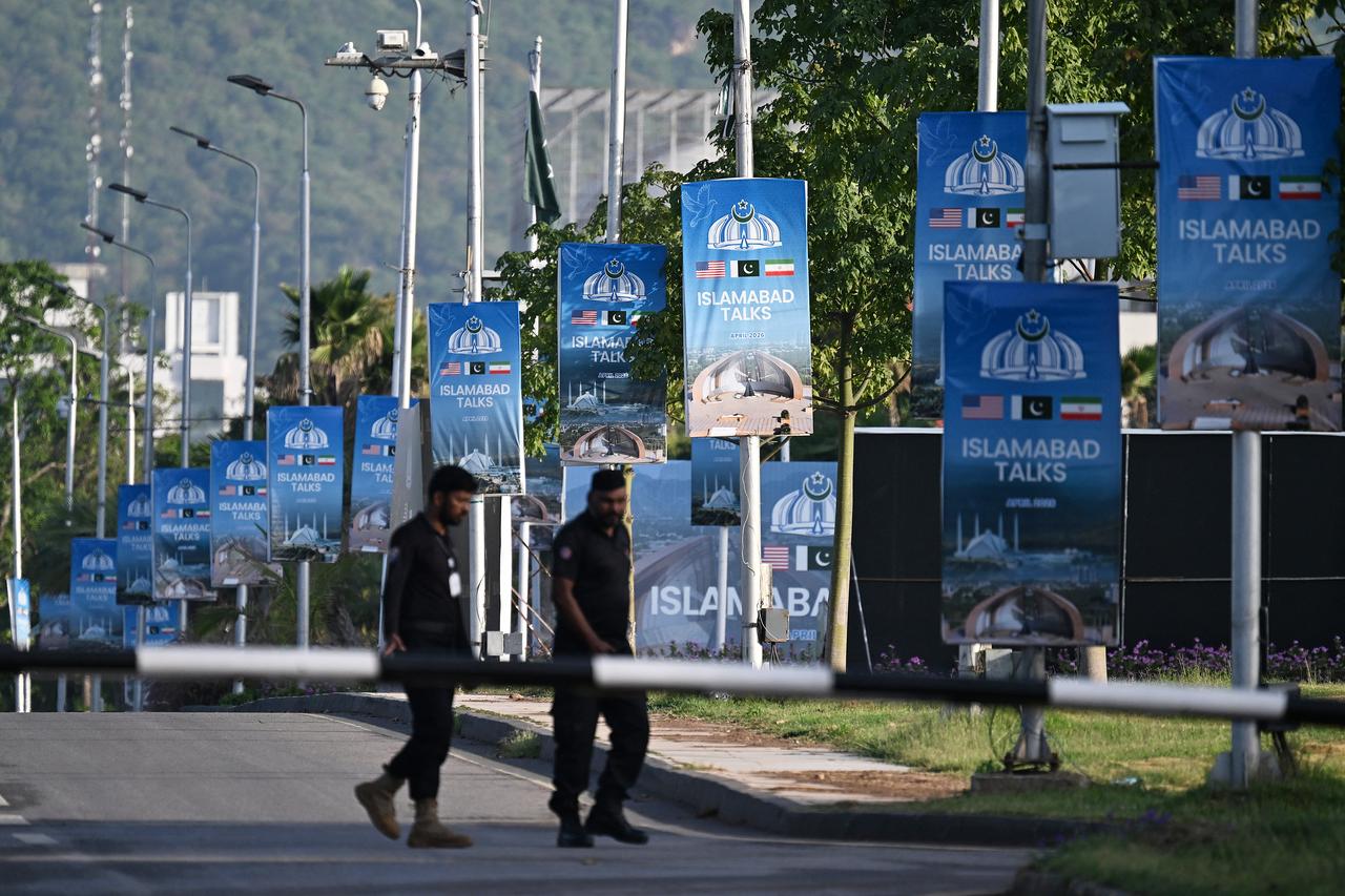 Police officers walk past posters highlighting Pakistan's mediation of Iran–US peace talks near the Serena Hotel at the Red Zone area in Islamabad, Pakistan on April 25, 2026. (AFP Photo)
