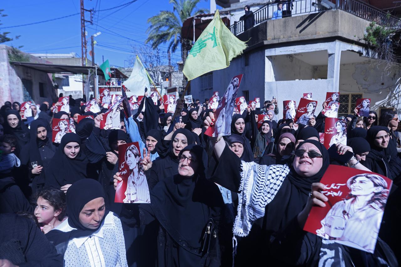 Mourners hold the portraits of Lebanese journalist Amal Khalil during her funeral procession in Bissariye town, south of Sidon, Lebanon on April 23, 2026. (AFP Photo)