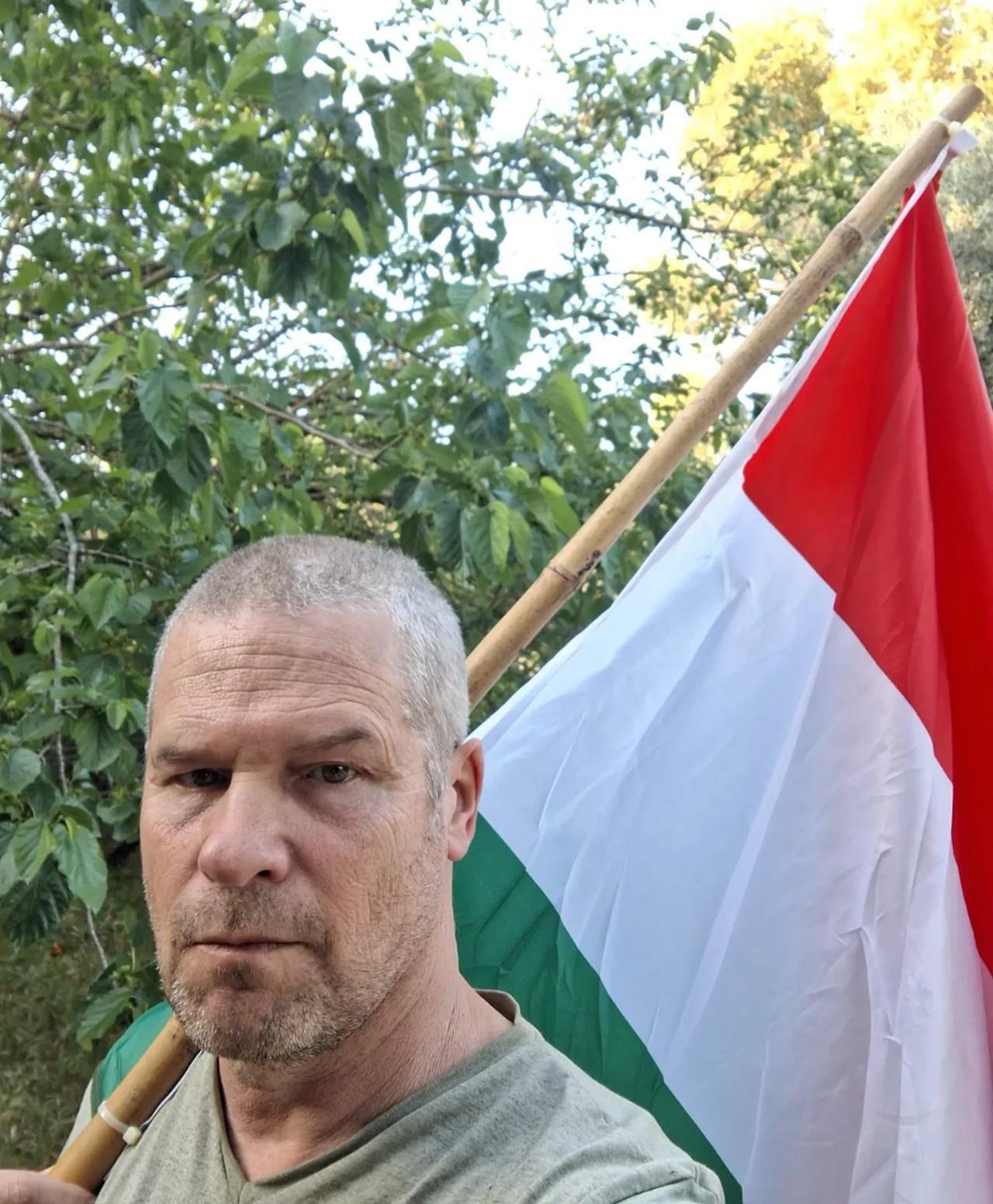 The protester holding the Hungarian flag that was taken from him, accessed on April 25, 2026. (Photo via Haaretz)