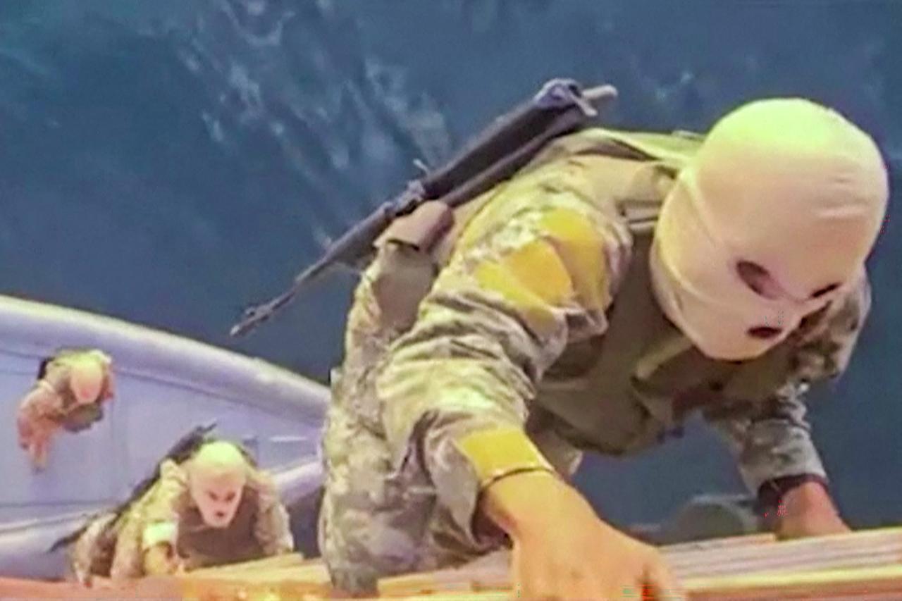 This screen grab taken from undated video footage released by Iran's Revolutionary Guards (IRGC) on April 23, 2026, shows IRGC naval forces boarding a ship (Photo by IRIB TV/AFP)