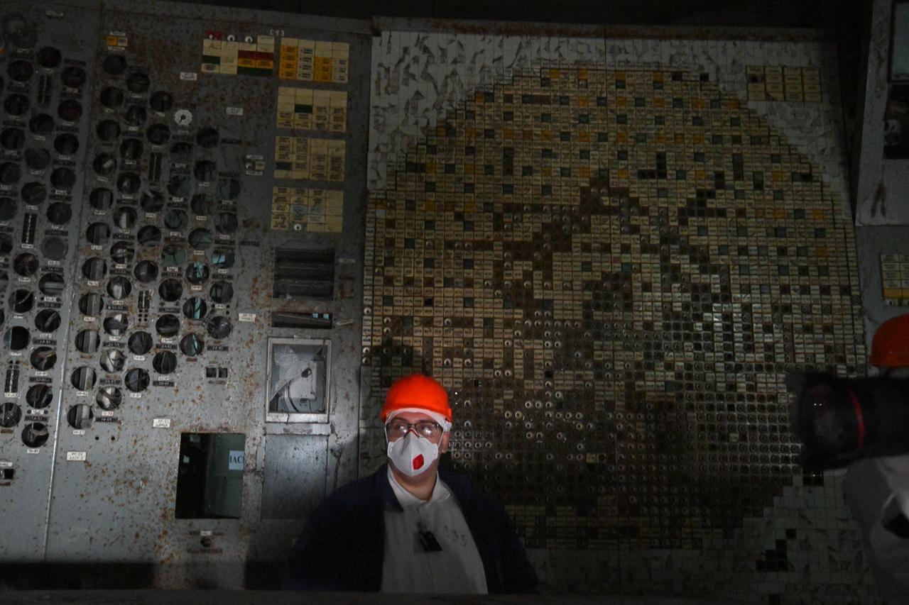 An employee of the Chernobyl Nuclear Power Plant walks in the control room of the destroyed 4th block of the plant on April 23, 2026. (AFP Photo)