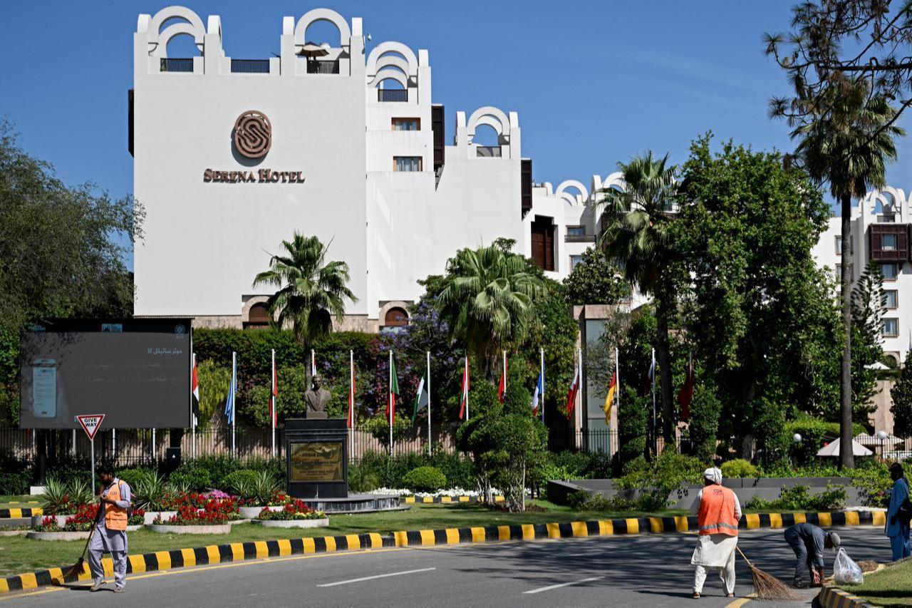 Sanitation workers sweep a street in front of the Serena Hotel, which hosted the first round of US-Iran peace talks in Islamabad on April 26, 2026. (AFP Photo)