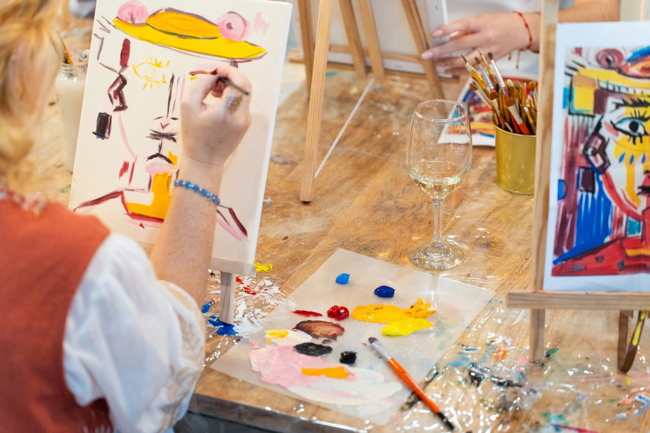A participant paints during a sip-and-paint workshop (Adobe Stock Photo)