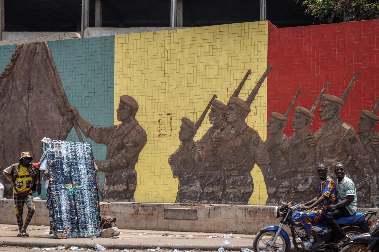 A motorcyclist rides past a monument in support of the Malian Army in Bamako on April 26, 2026. (AFP Photo)