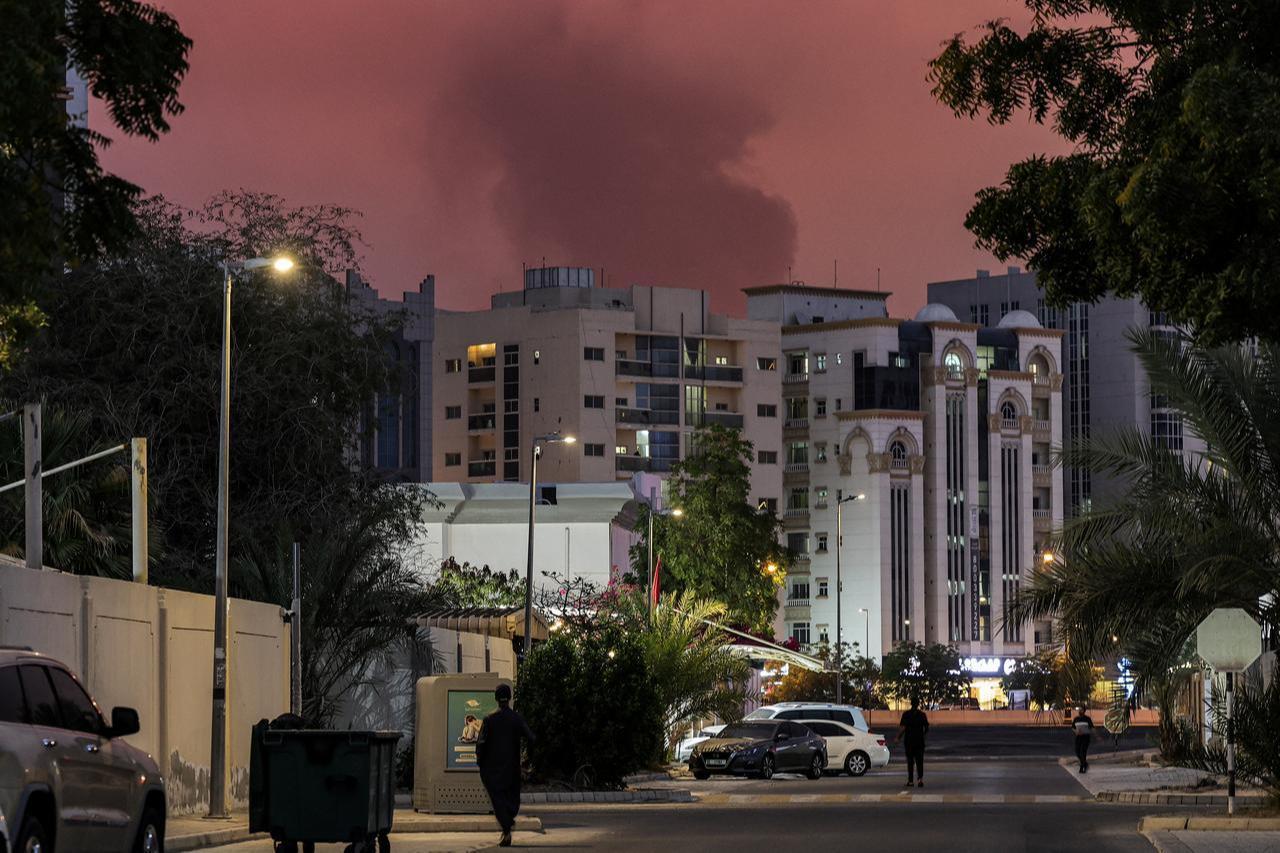 Bystanders watch as a plume of black smoke rises from the port of Fujairah in the gulf emirate of Fujairah, UAE on March 4, 2026. (AFP Photo)