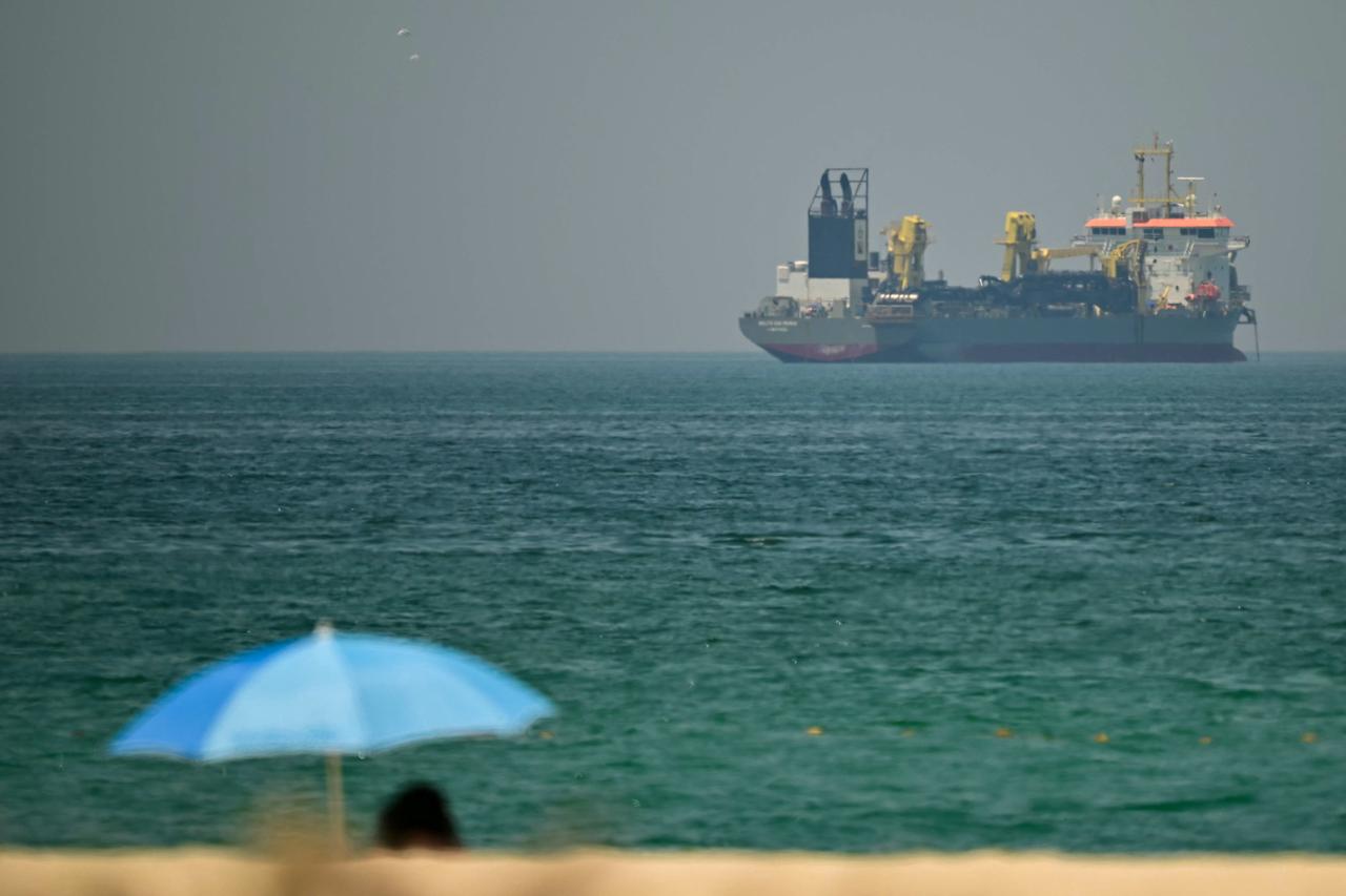 A commercial vessel is seen off the coast of Dubai on April 20, 2026. (AFP Photo)