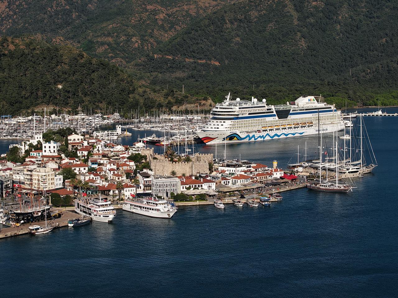 The Italy-flagged cruise ship Aida Stella is seen docked near Marmaris town center, delivering thousands of tourists to the popular resort destination in Türkiye, April 19, 2026. (AA Photo)