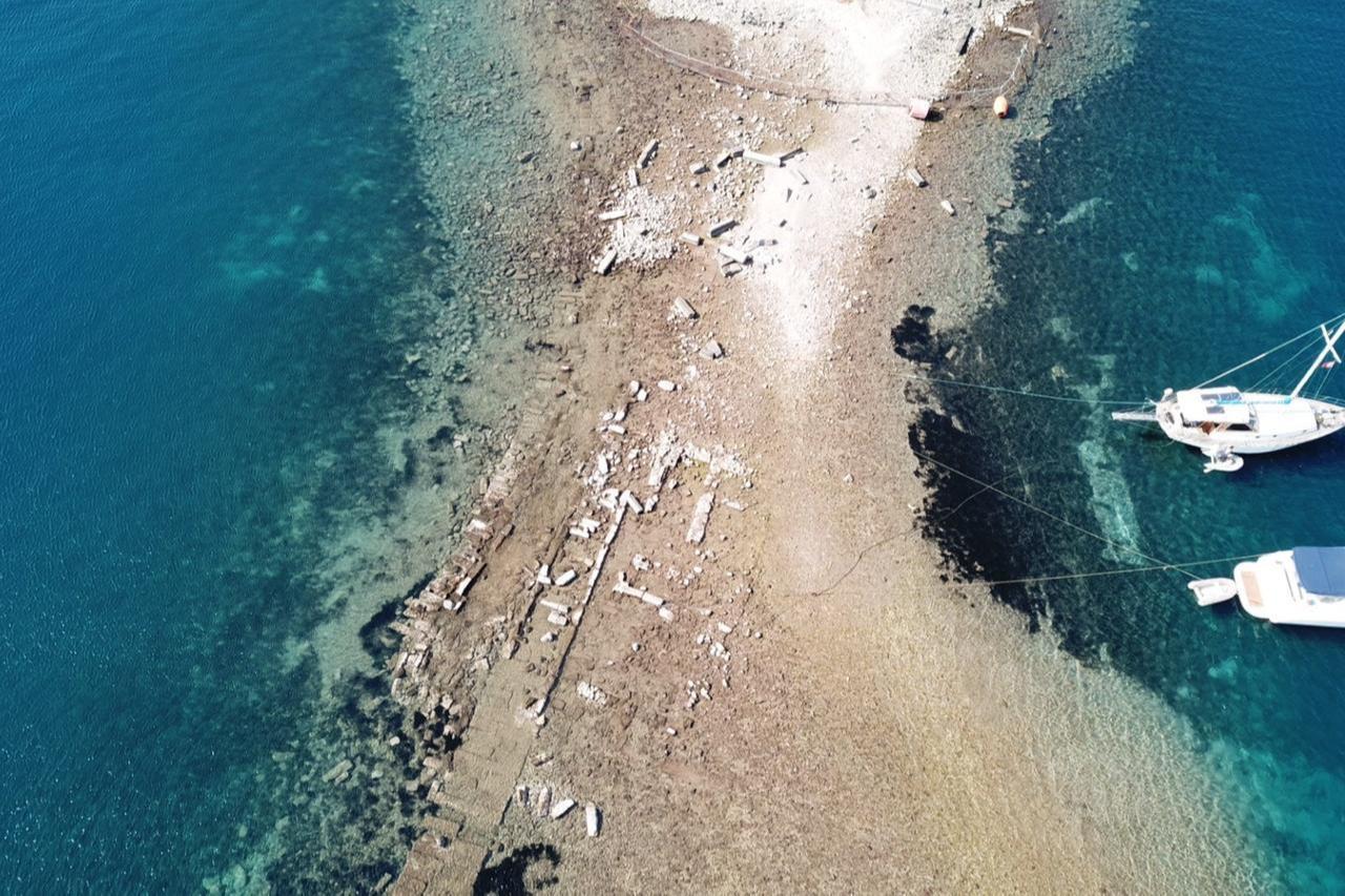 The retreat of the sea has uncovered ancient history, revealing the 3,500-year-old King’s Road leading to the historic city of Myndos in Gumusluk Bay, Bodrum, Mugla, March 6, 2026. (IHA Photo)