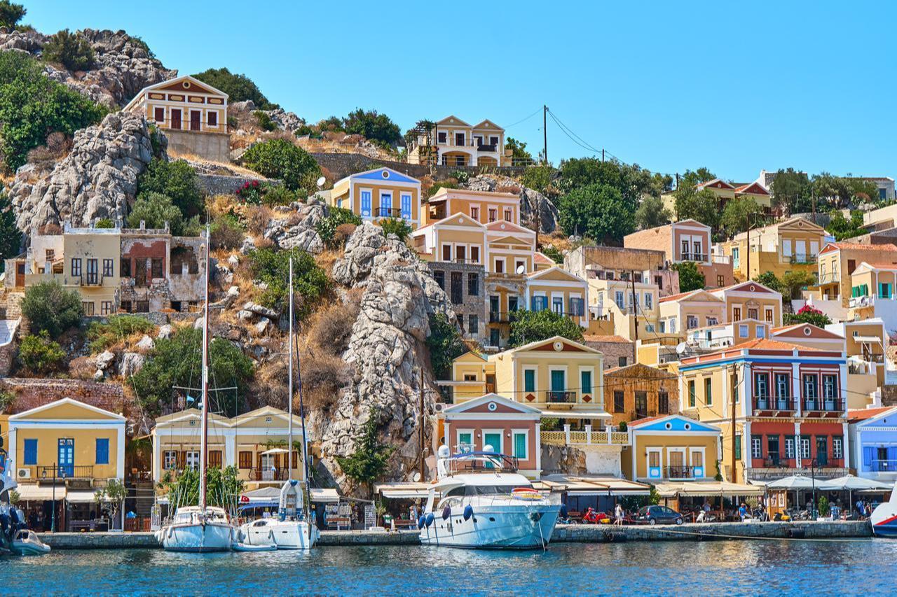 Colorful hillside houses of Symi Island, Greece. (Adobe Stock Photo)