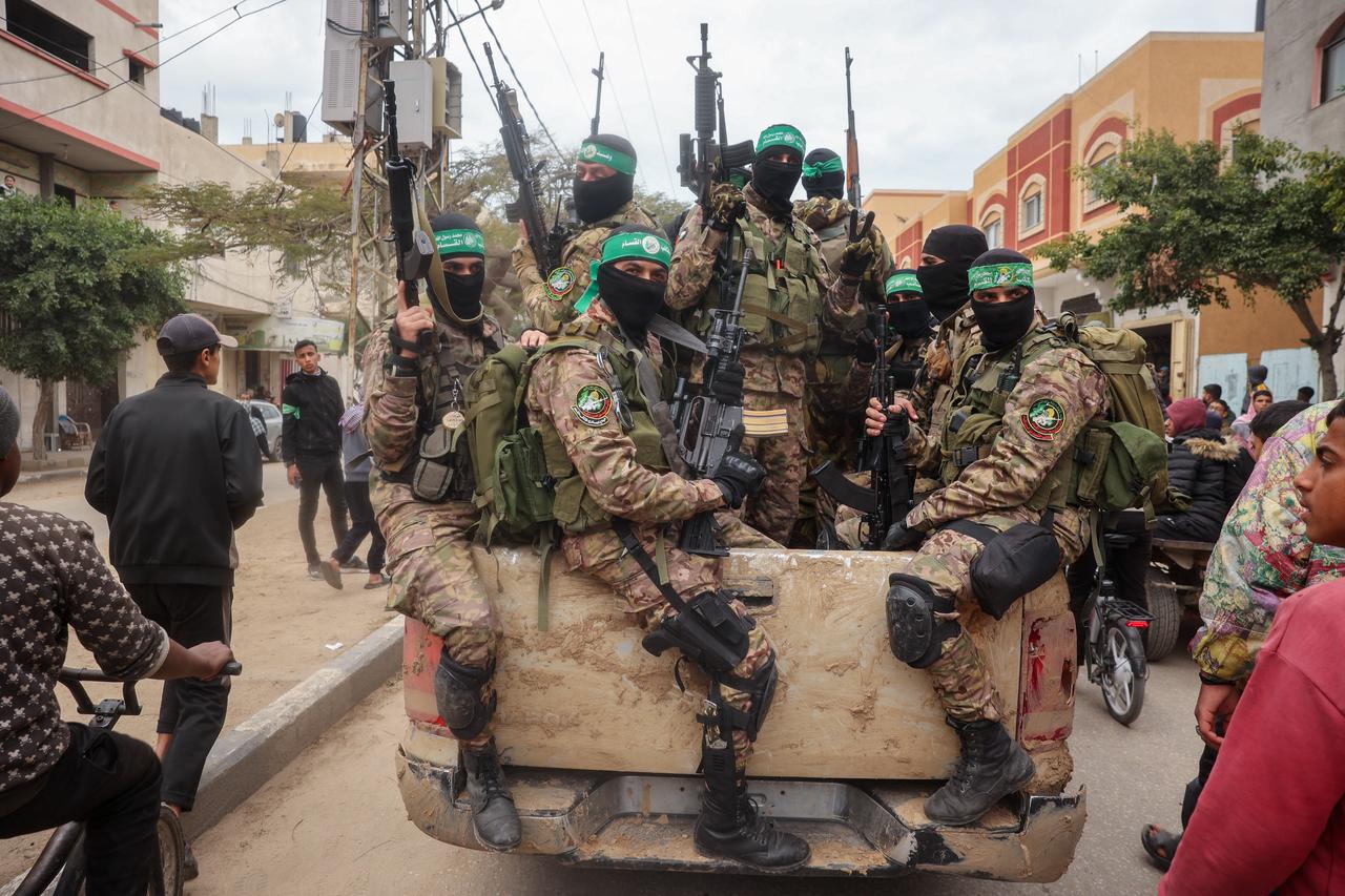 Hamas fighters patrol a street before they hand over three Israeli hostages to a Red Cross team in Deir el-Balah, central Gaza, February 8, 2025. (AFP Photo)