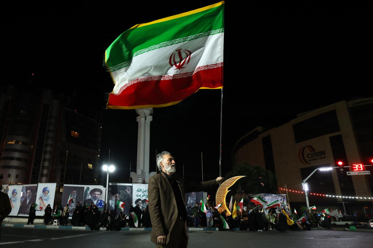 A man holds an Iranian flag during a rally in support of Iran's supreme leader Mojtaba Khamenei at Sadeghyeh Square in Tehran on April 27, 2026. (AFP Photo)