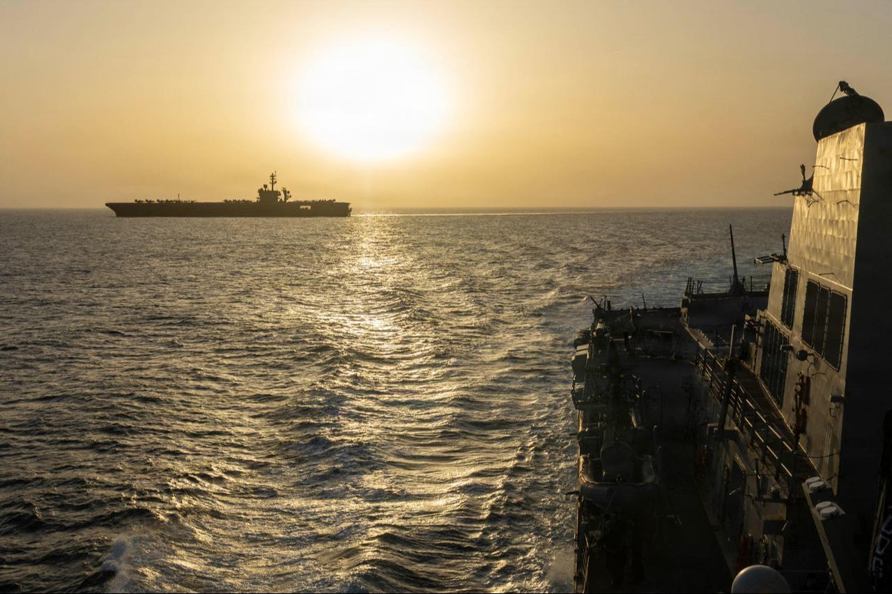 This US Navy handout photograph released on April 17, 2026, by US Central Command Public Affairs shows USS Abraham Lincoln (L) conducting blockade operations in the Arabian Sea on April 16, 2026. (AFP Photo)