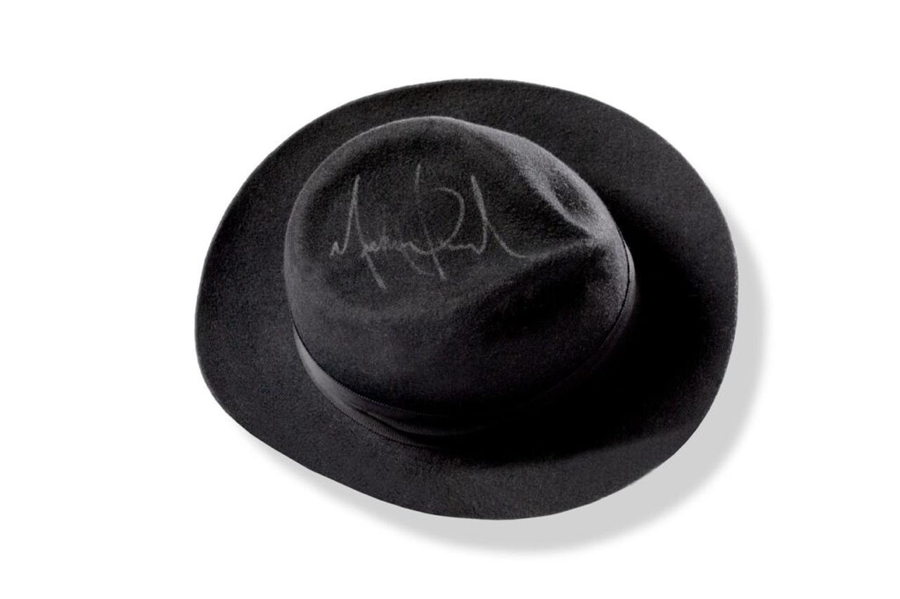 Black hat associated with Michael Jackson and signed by the artist, reflecting one of the most recognizable elements of his stage identity. (Photo via Aguttes)