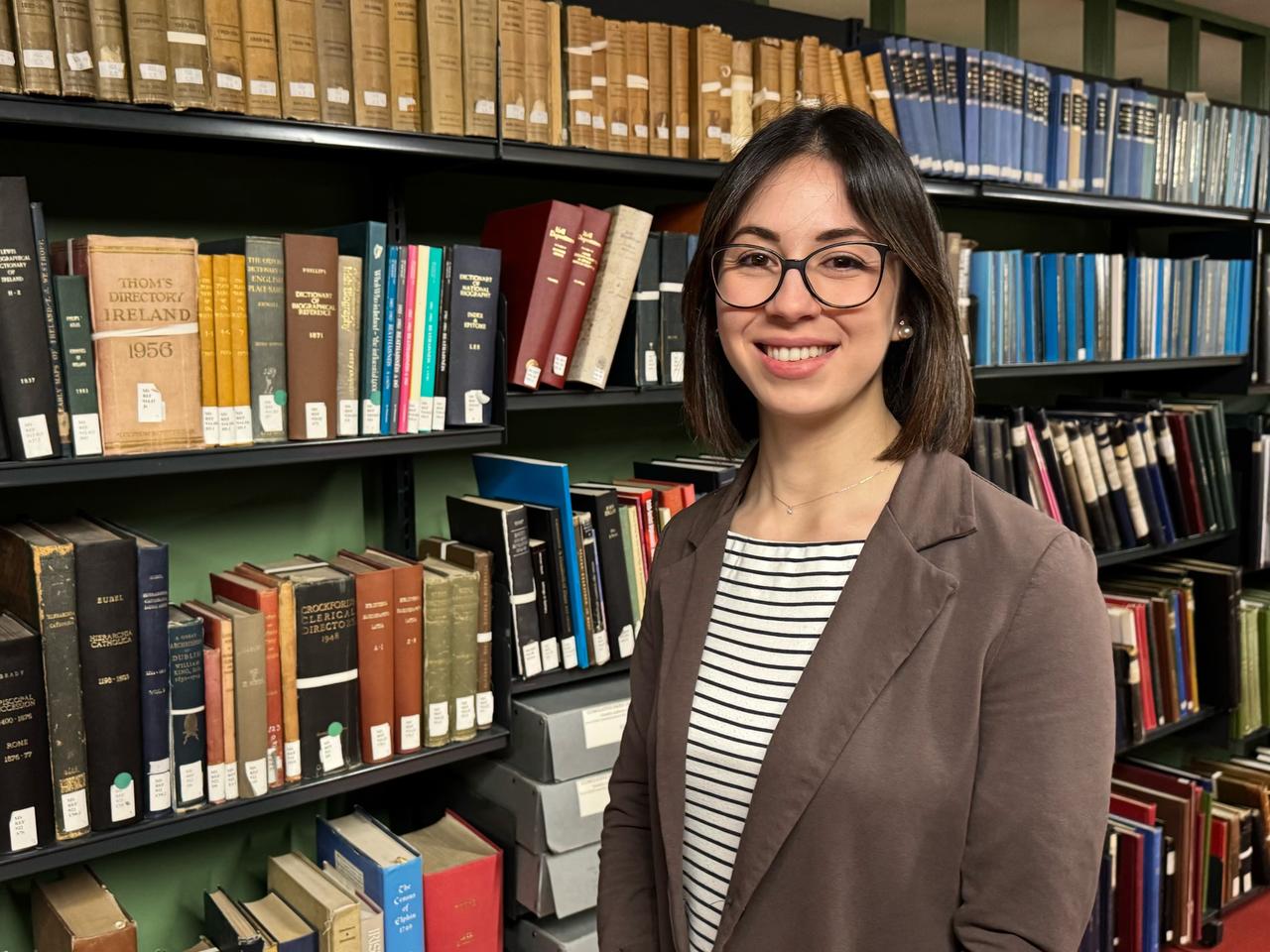 Researcher Elisabetta Magnanti poses among archival collections, April 30, 2026. (Courtesy of TCD)
