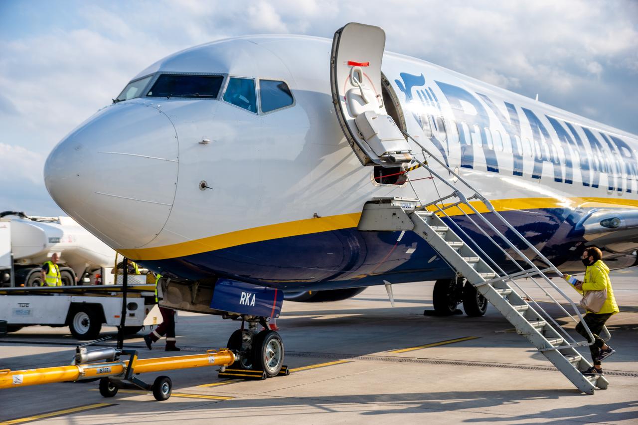 A Ryanair Boeing 737-800 stands on the tarmac with boarding stairs attached. (Adobe Stock Photo)
