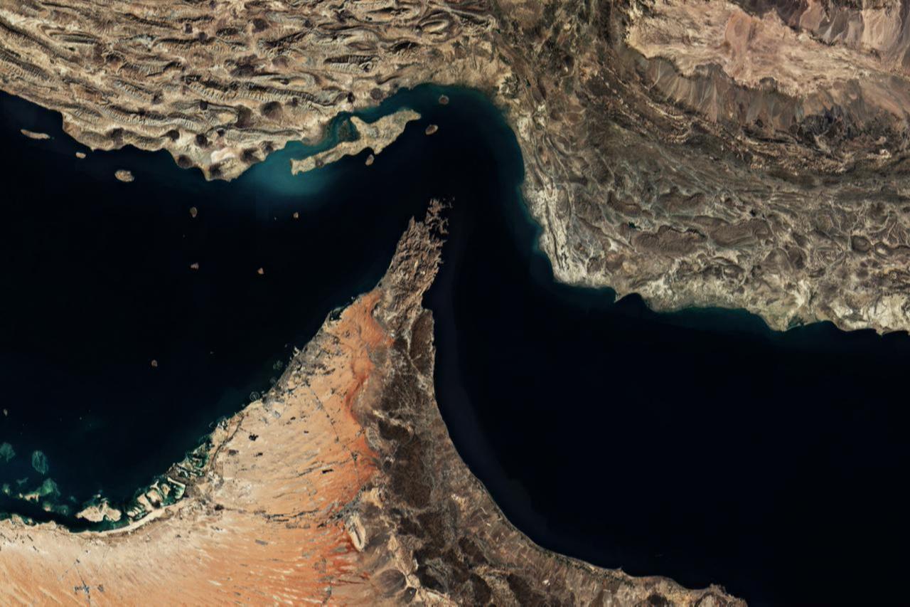 Satellite view of the Strait of Hormuz, showing the narrow maritime passage between Iran (top) and Oman’s Musandam Peninsula (bottom). (Adobe Stock Photo)