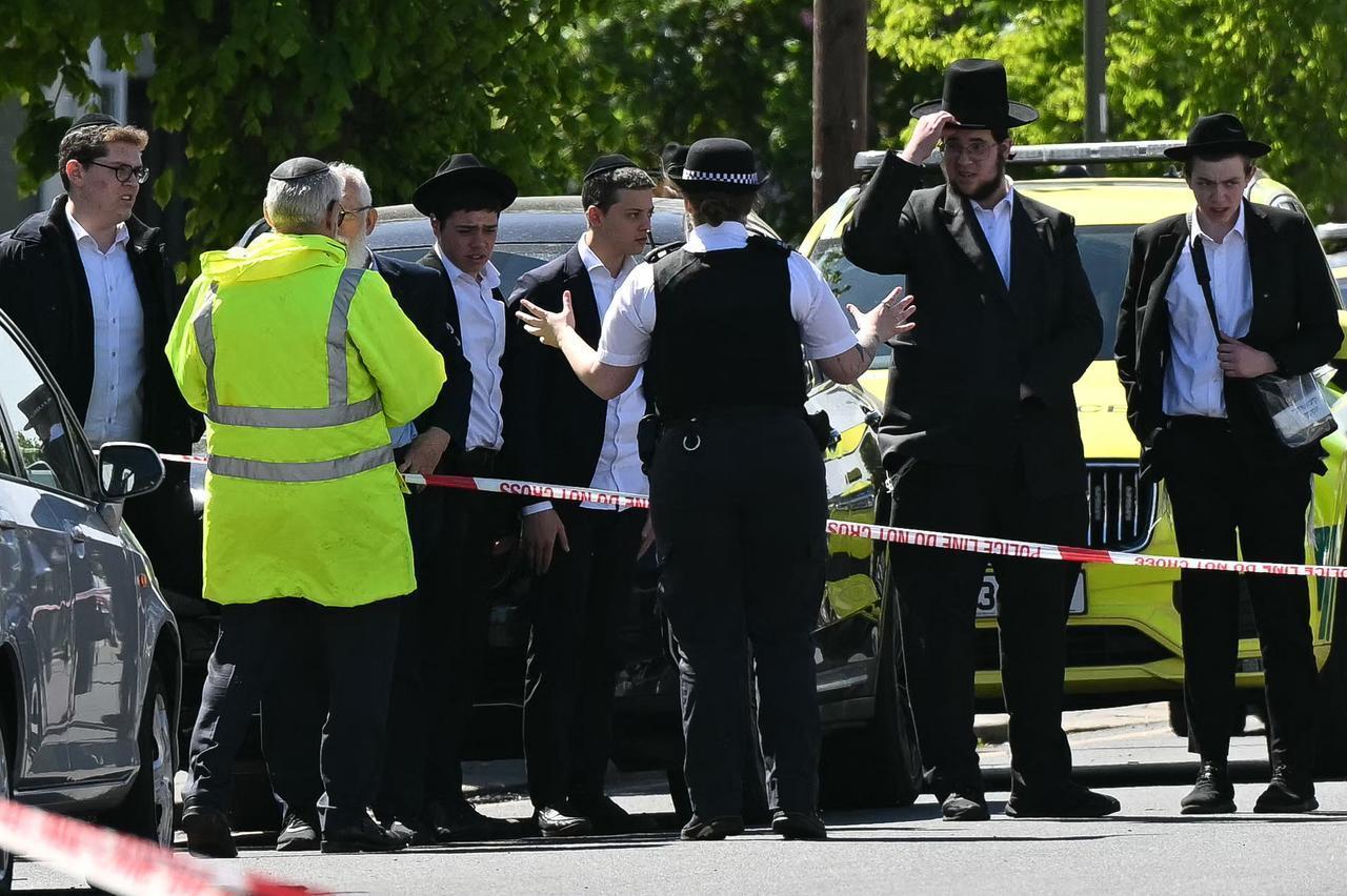 Local residents look on from outside a cordoned off area in the Golders Green neighbourhood of north London on April 29, 2026, following the stabbing to two people nearby. (AFP Photo)