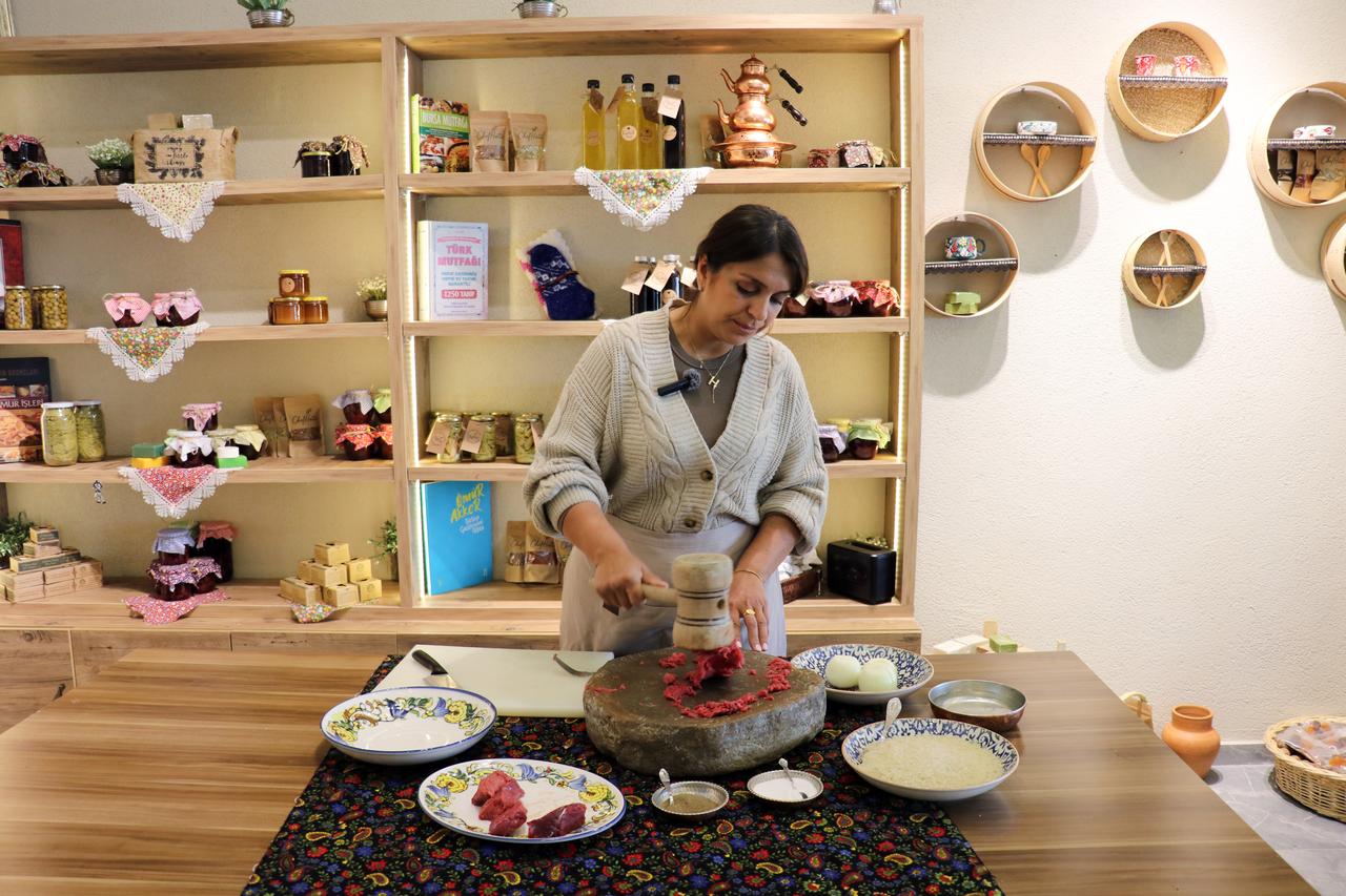 Chef Hatice Sari pounds lean beef on a stone using a wooden mallet to prepare traditional Abdigor kofte in Dogubayazit, Agri, Türkiye, March 2026. (AA Photo)