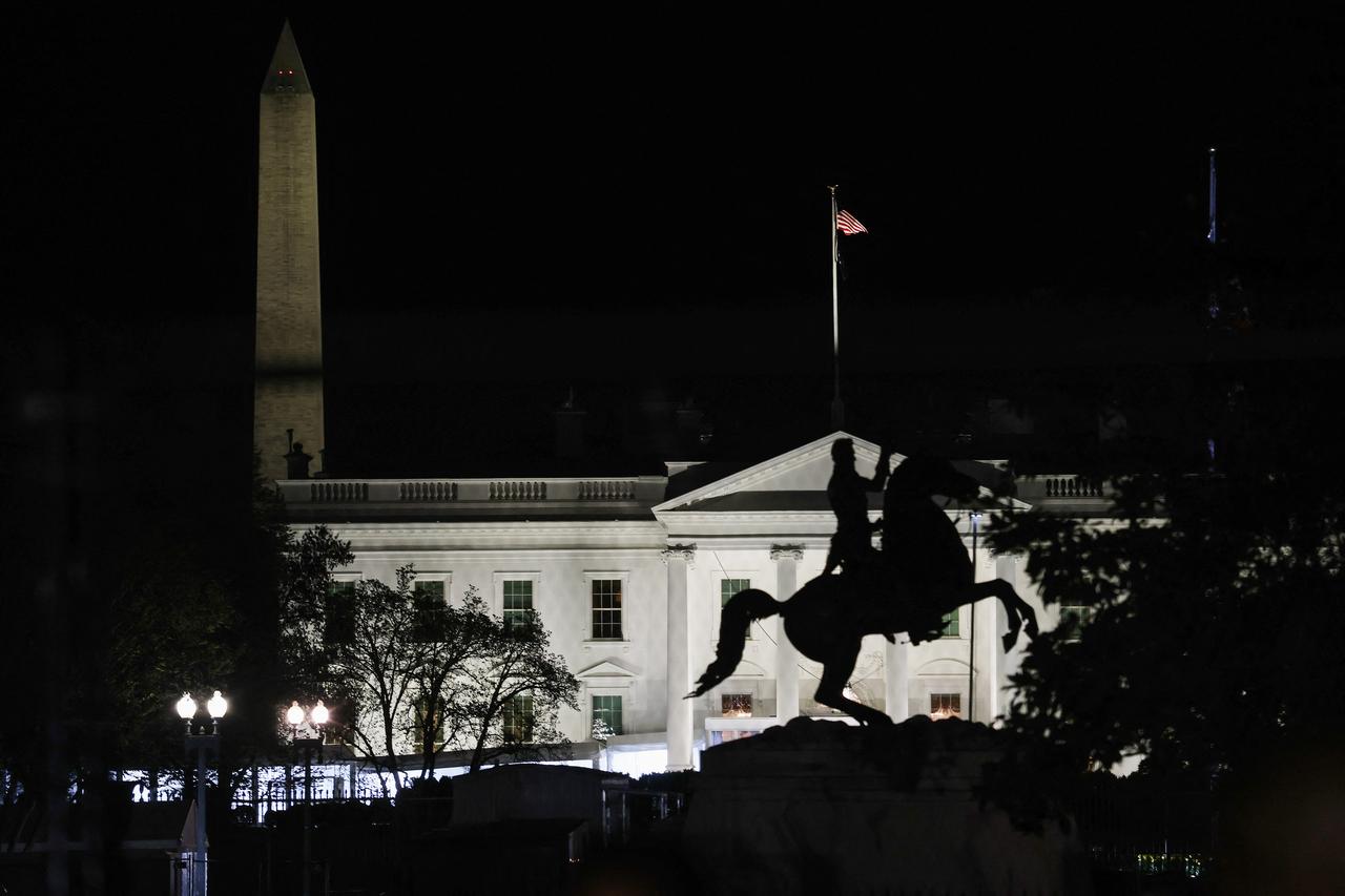 People walk in front of the White House on April 1, 2026, in Washington, DC. (AFP Photo)
