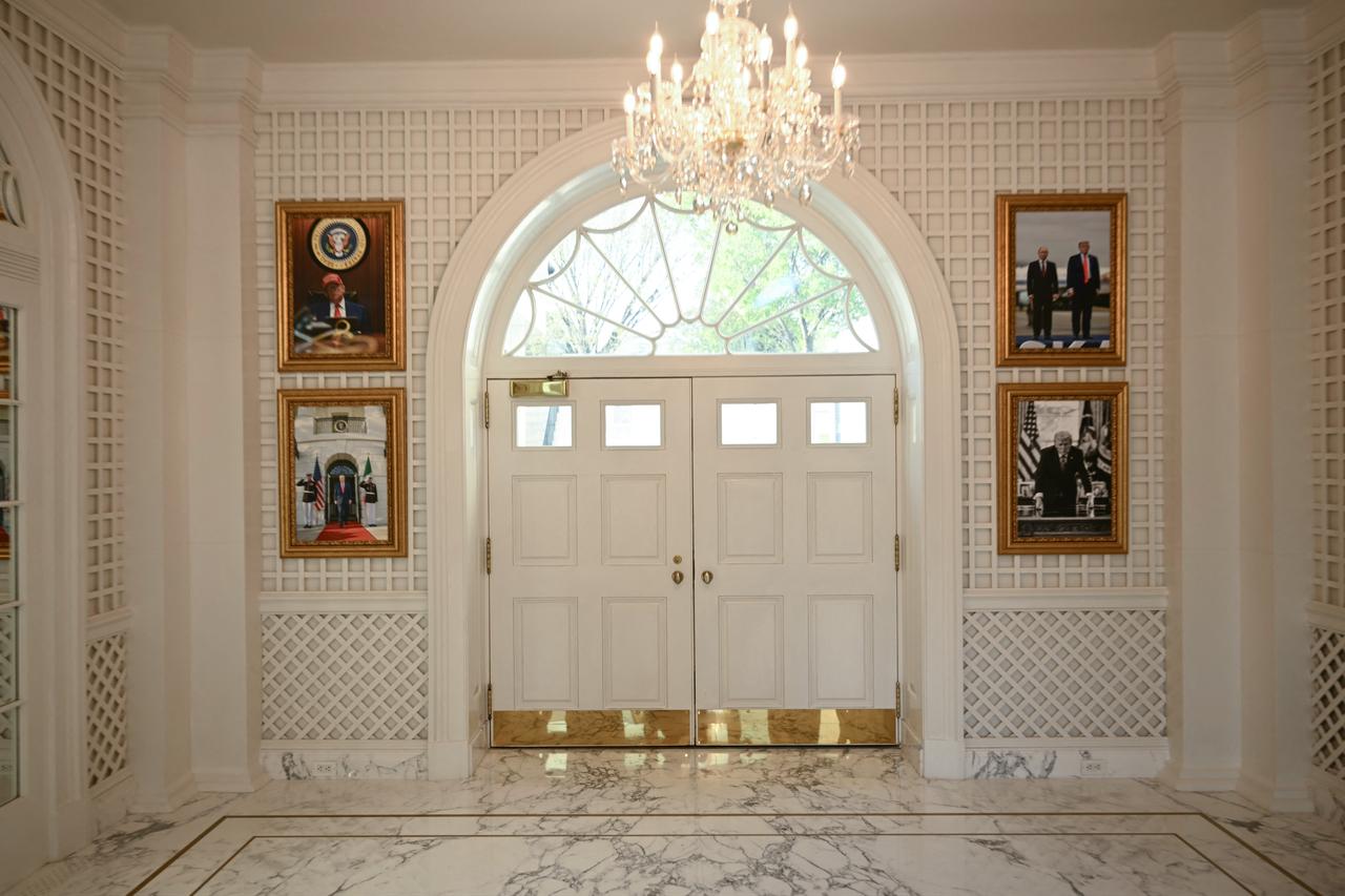 Pictures of US President Donald Trump, including one with Russian President Vladimir Putin, hang in the Palm Room of the White House in Washington, DC, on March 31, 2026. (AFP Photo)