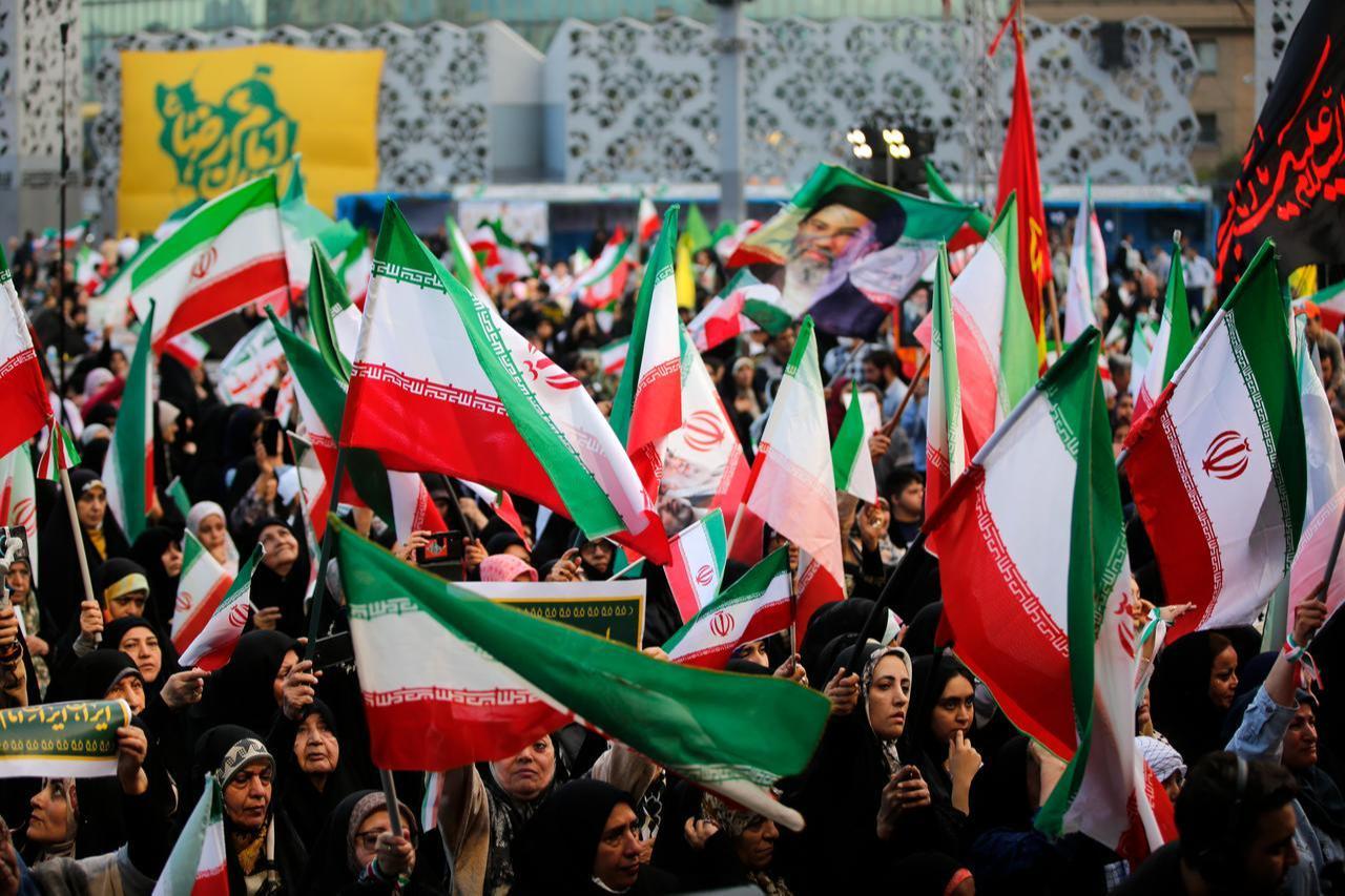 Iranians carry flags as they participate in a march pledging loyalty to new leader Mojtaba Khamenei, stretching from Imam Hussein Square to Azadi Square in Tehran, Iran, April 29, 2026. (AA Photo)