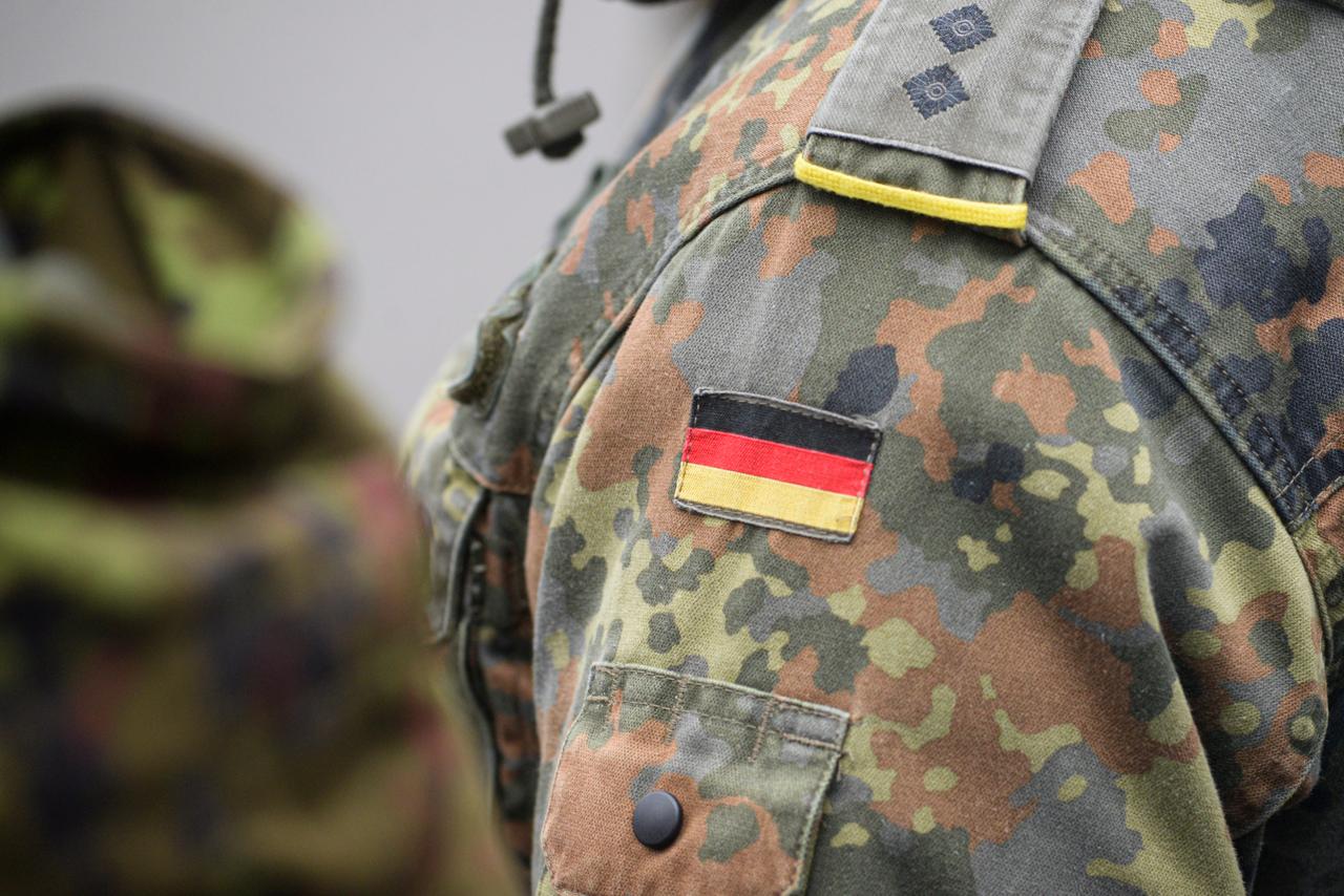 Uniform of the German army with the German flag on the shoulder. German military, selective focus. (Adobe Stock photo)