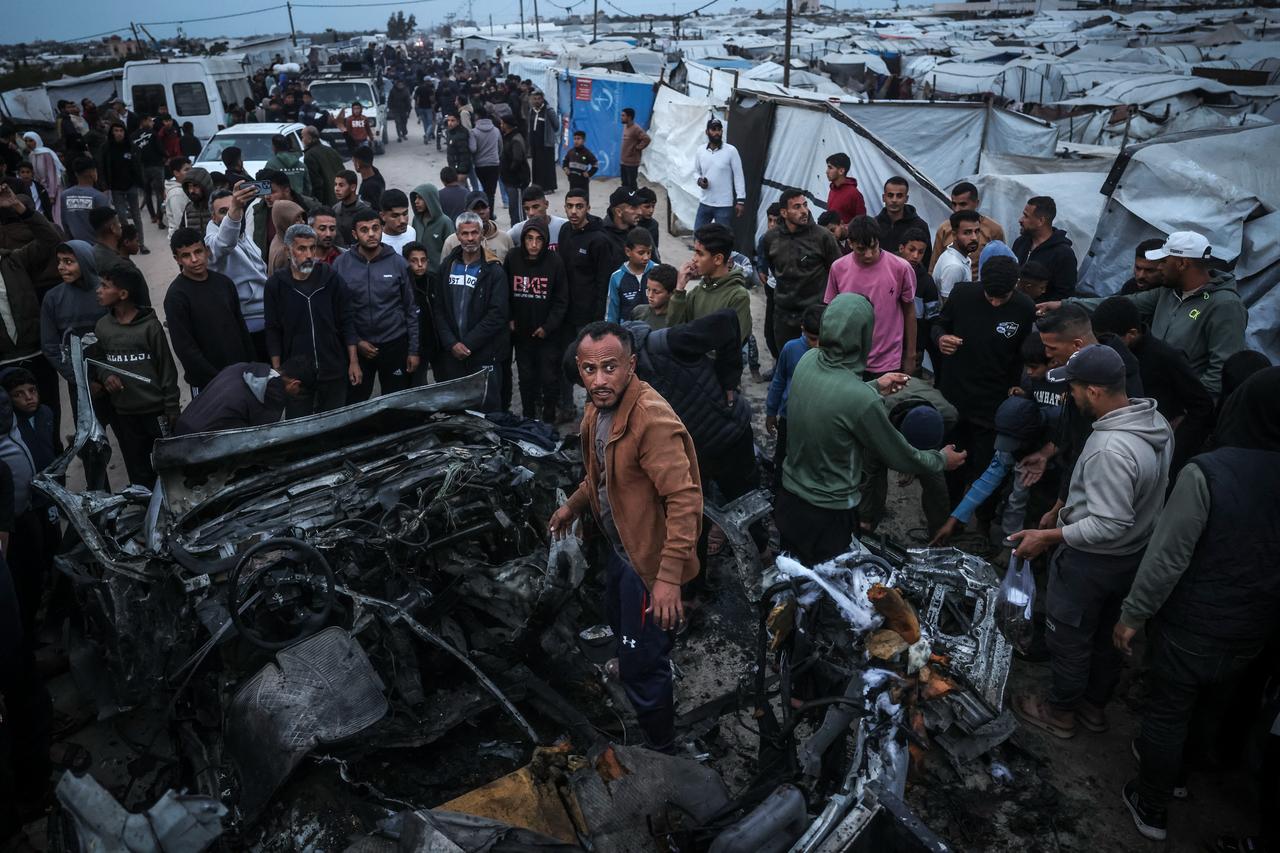 People gather at the site of an Israeli strike on a police vehicle in Khan Yunis, in the southern Gaza Strip, April 24, 2026. (AFP Photo)
