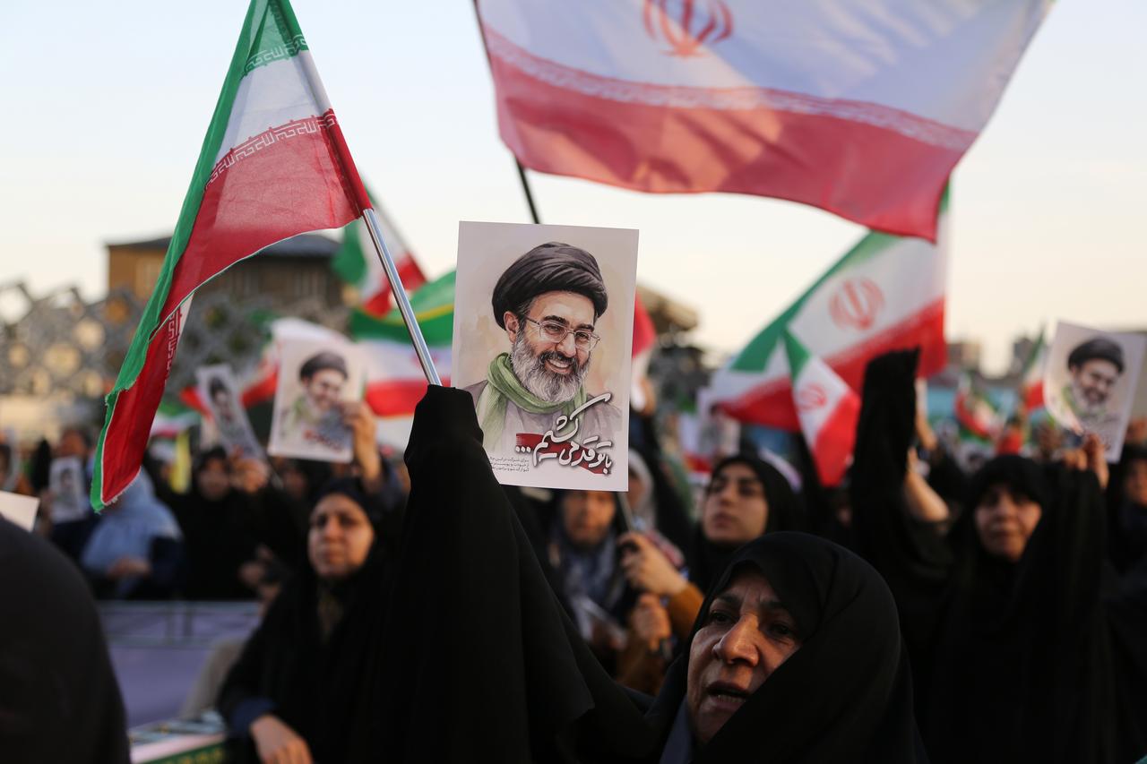 Iranians carry flags as they participate in a march pledging loyalty to new leader Mojtaba Khamenei in Tehran, Iran, April 29, 2026. (AA Photo)