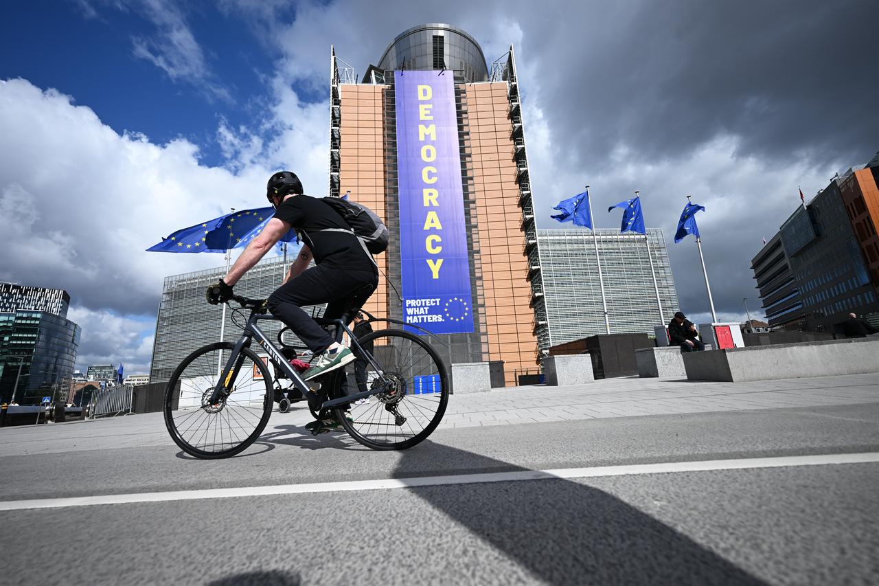 A view shows a banner reading "DEMOCRACY" displayed on the Berlaymont building, headquarters of the European Commission, in Brussels, Belgium, April 20, 2026. (AA Photo)