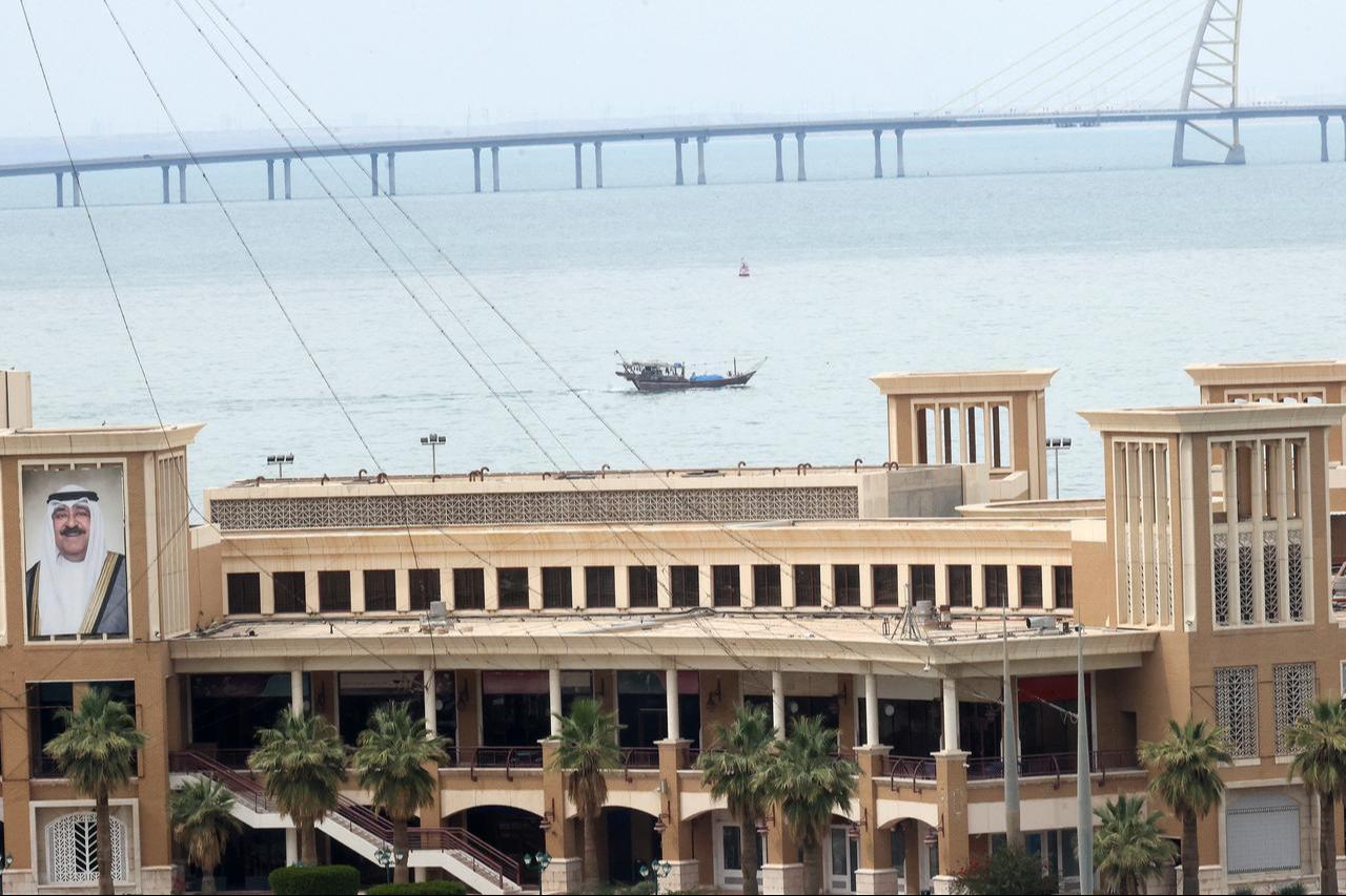 This picture shows a fishing boat sailing in Gulf waters in Kuwait City with the Sheikh Jaber al-Ahmad al-Sabah causeway visible in the background on April 2, 2026. (AFP Photo)