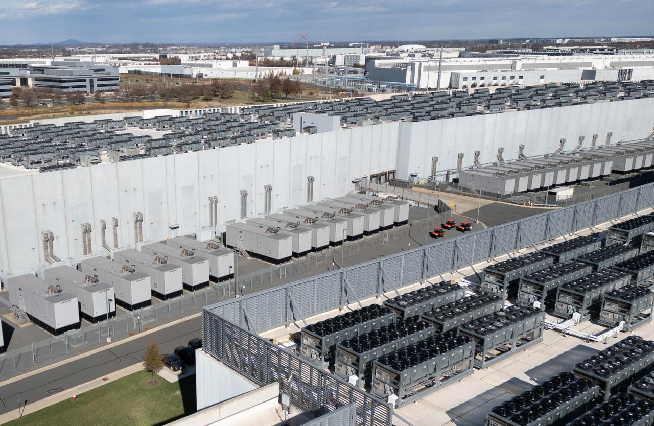 An aerial view shows cooling vent fans on the roof next to generators on the lower level of a Digital Realty data center in Ashburn, Virginia on November 12, 2025. (AFP Photo)