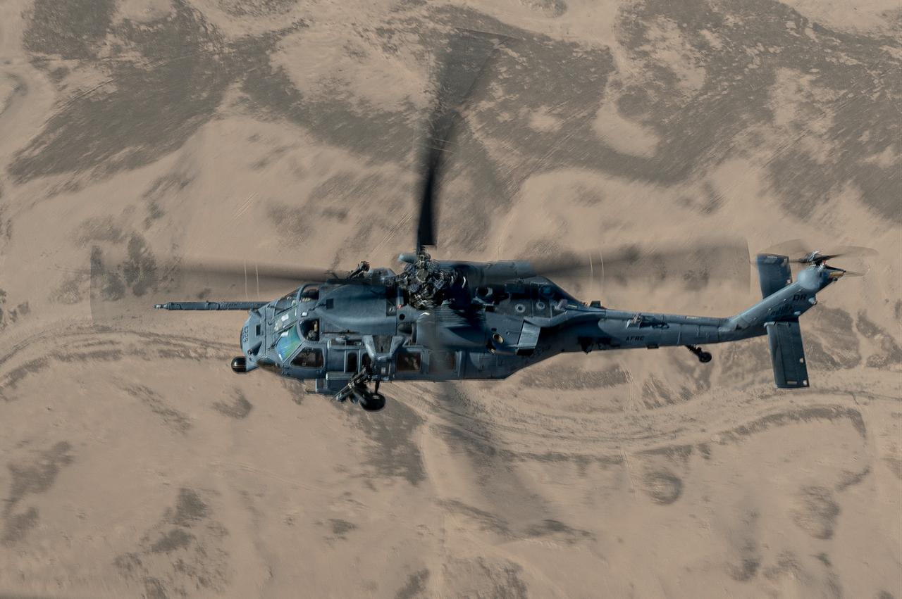 A U.S. Air Force HH-60G Pave Hawk assigned to the 1st Expeditionary Rescue Group scans the desert during a combat search and rescue and personnel recovery agile combat employment exercise within the U.S. Central Command area of responsibility, Dec. 3, 2022. (Photo via U.S. Air Force)