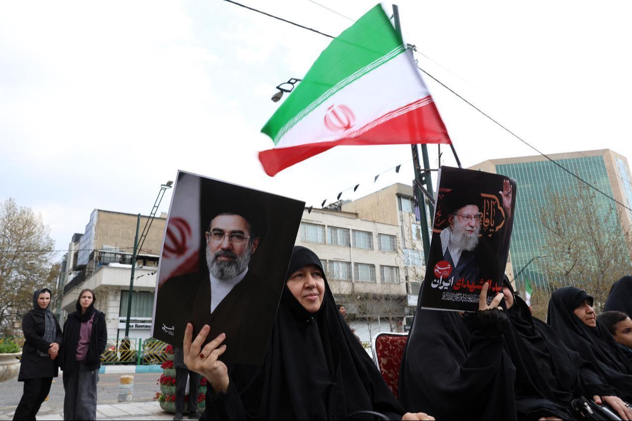 Iranian women hold portraits of Iran's supreme leader, Mojtaba Khamenei (R), and Iran’s slain supreme leader, Ali Khamenei (L), while gathering in front of Tehran's Mellat park, April 2, 2026. (AFP Photo)