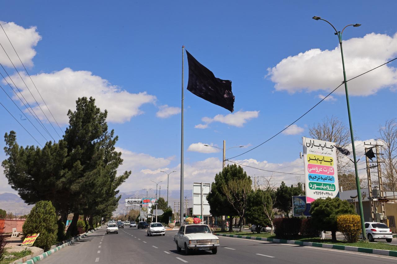 A black flag flutters over the city of Karaj, southwest of Tehran, on April 3, 2026. (AFP Photo)