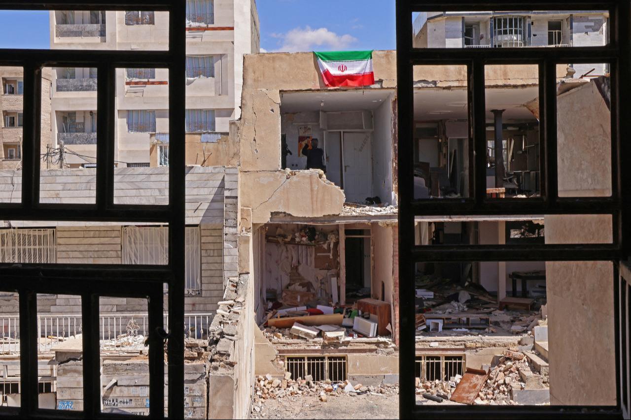 An Iranian flag is seen on a residential building that was damaged by recent strikes at Vahdat town in Karaj, southwest of Tehran, Iran on April 3, 2026. (AFP Photo)