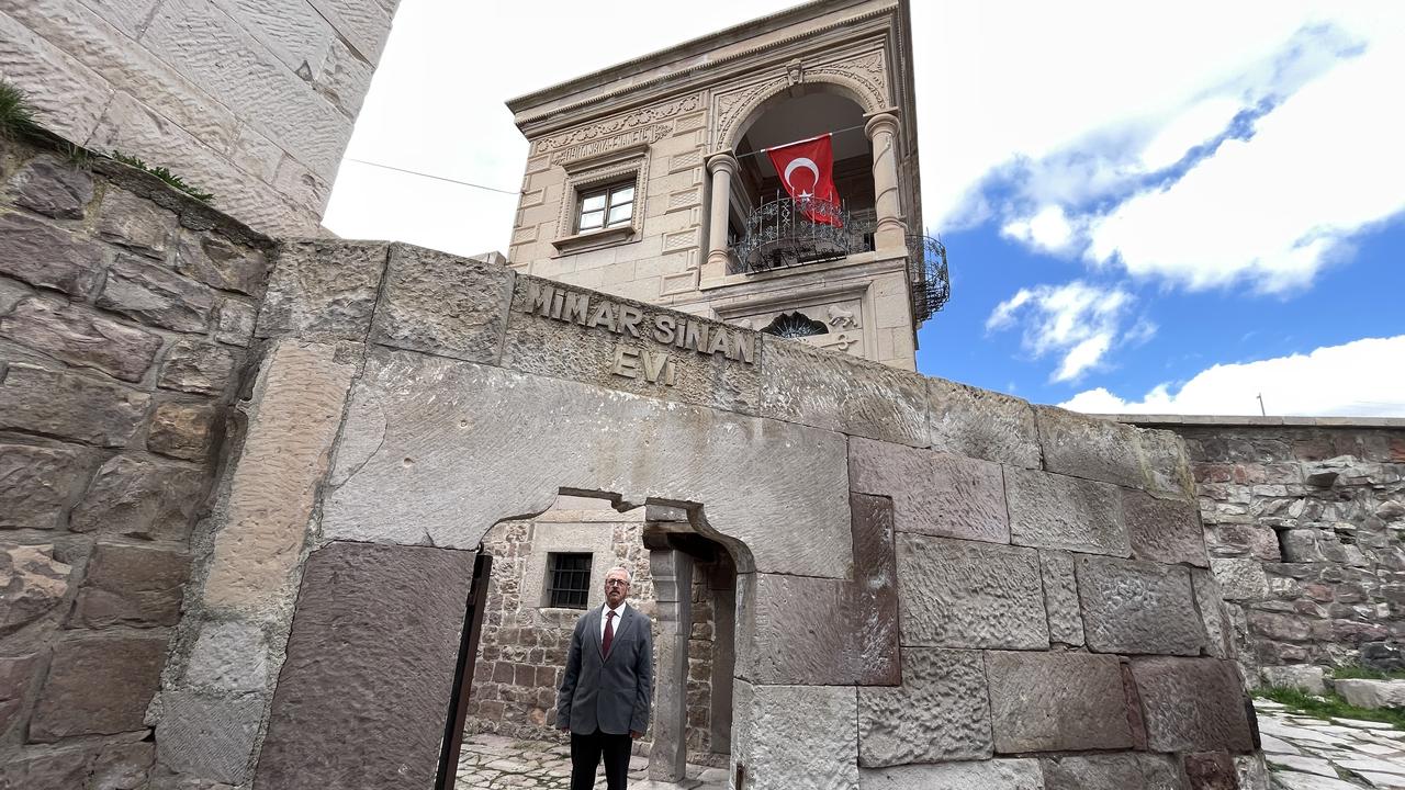 Ahmet Bekdas stands at the entrance of the house where Ottoman chief architect Sinan was born in the Agirnas neighborhood of Kayseri, Türkiye, April 5, 2026. (AA Photo)