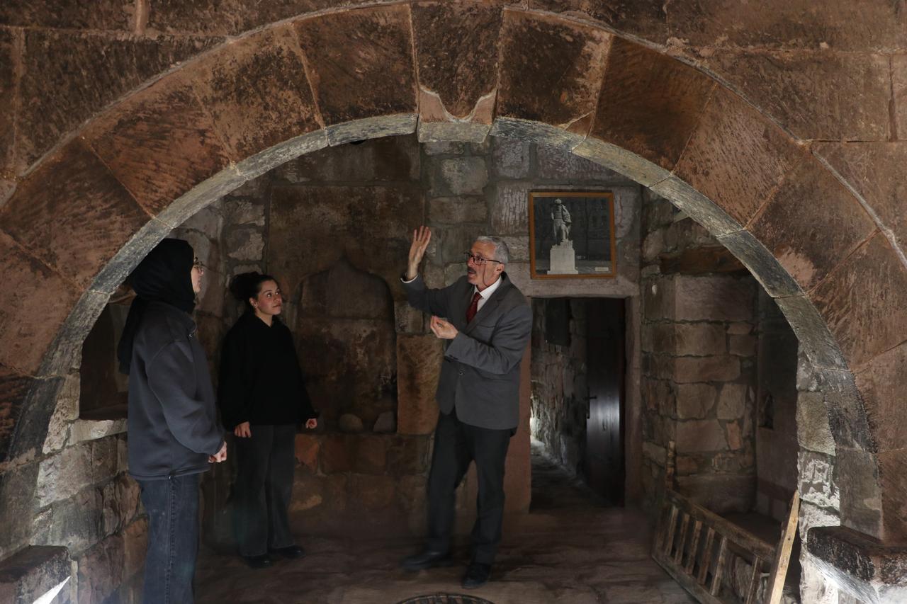 Ahmet Bekdas describes the arched interior spaces of Mimar Sinan’s childhood home to visitors in Agirnas, Kayseri, Türkiye, April 5, 2026. (AA Photo)