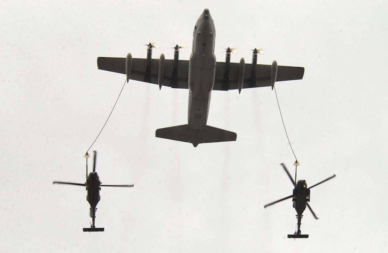 Two HH-60G Pave Hawk helicopters are refueled by an Alaska Air National Guard HC-130 P/N aircraft during Arctic Search and Rescue Exercise 05. (Photo via U.S. Air Force)