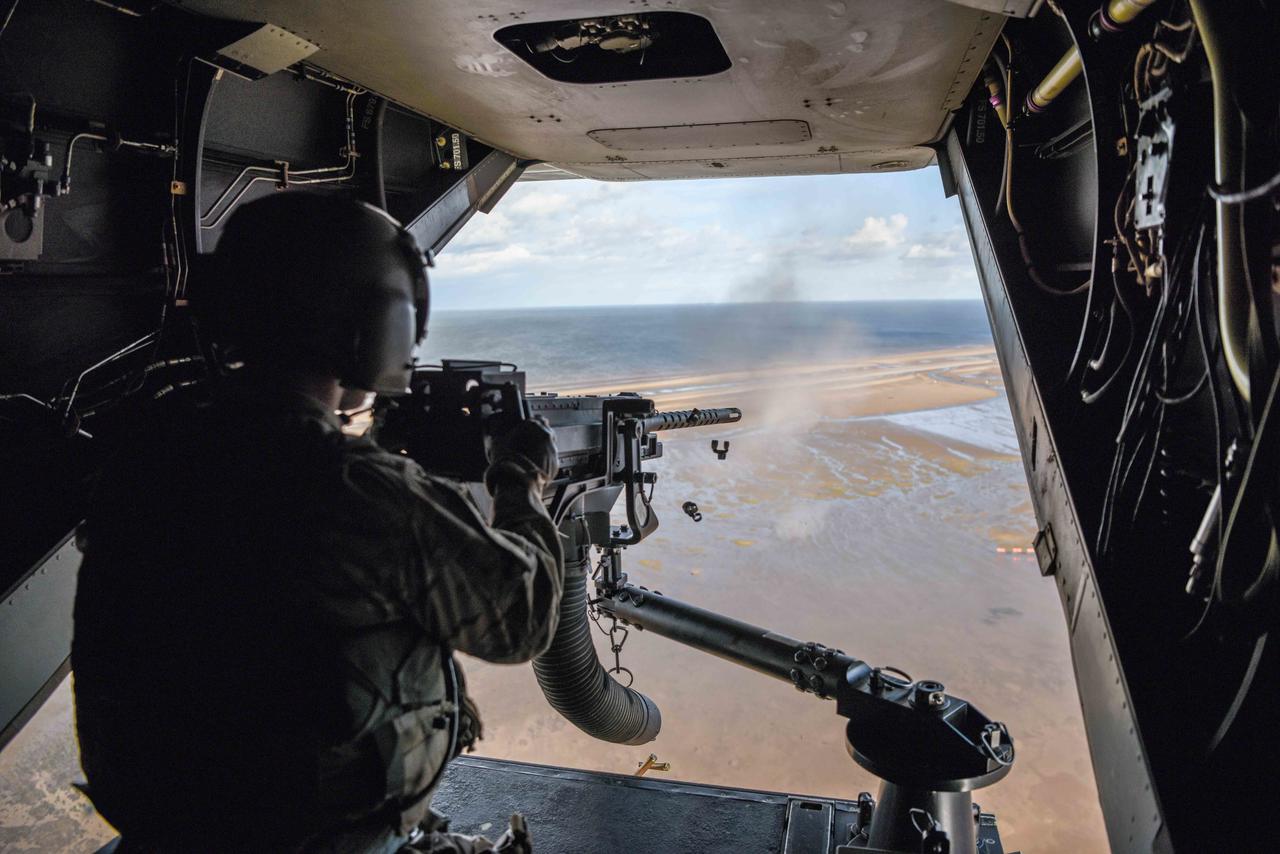 An Air Commando from the 7th Special Operations Squadron fires a .50 caliber machine gun aboard a CV-22 Osprey during a flight around southern England, Sept. 11, 2017. (Photo via U.S Air Force)