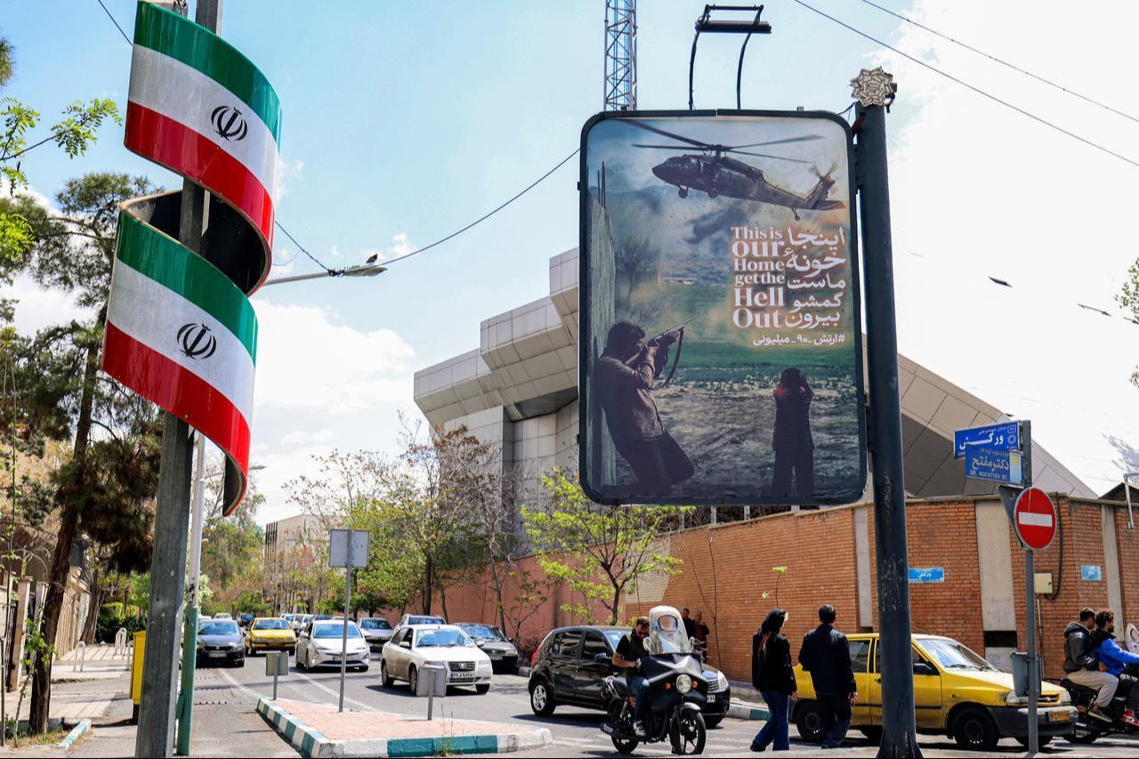 An anti-US banner depicting a helicopter being fired upon is displayed along a street in Tehran, Iran on April 6, 2026. (AFP Photo)