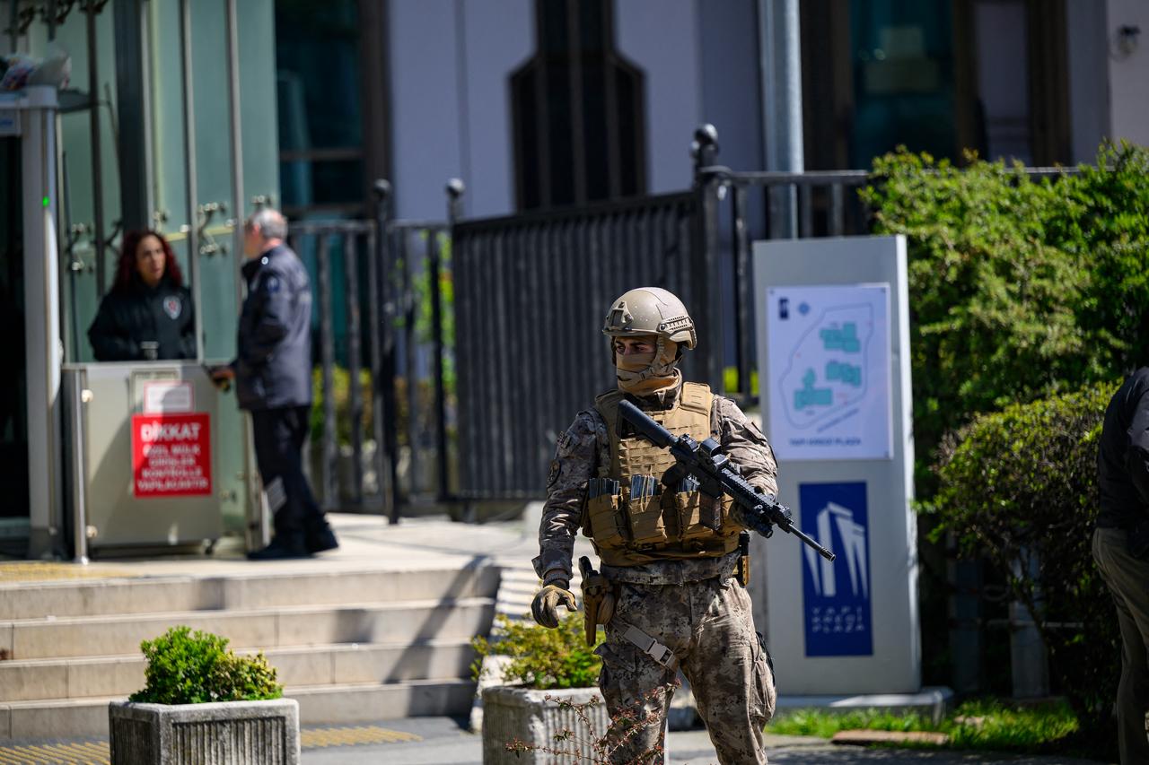 A police officer stands alert near the Israeli Consulate in Istanbul on April 7, 2026, following a shootout between gunmen and police. (AFP Photo)