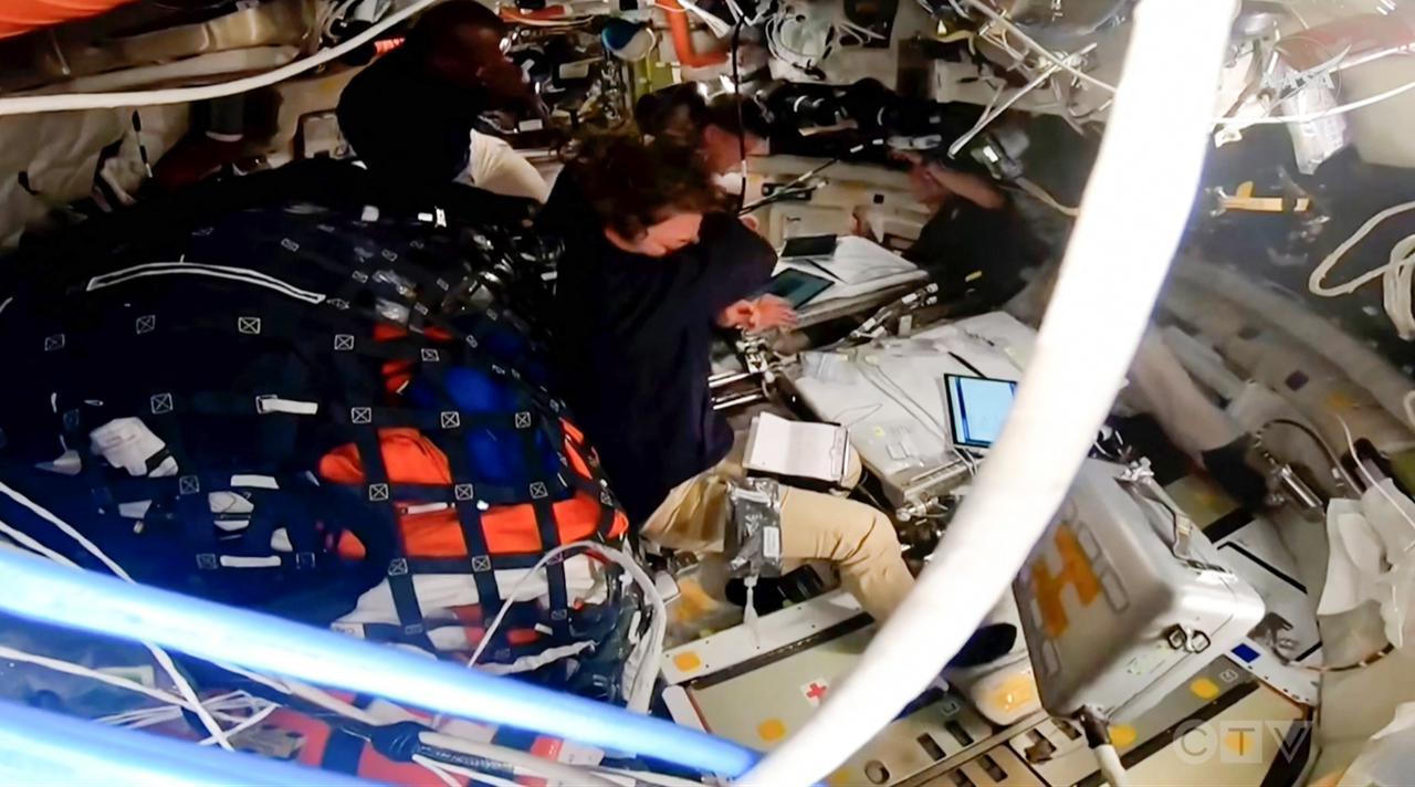 This screengrab from a NASA livestream shows Artemis II crew members wiping their tears after naming a lunar crater "Carroll" in honor of Wiseman’s late wife, aboard the Orion spacecraft on April 6, 2026. (AFP Photo)