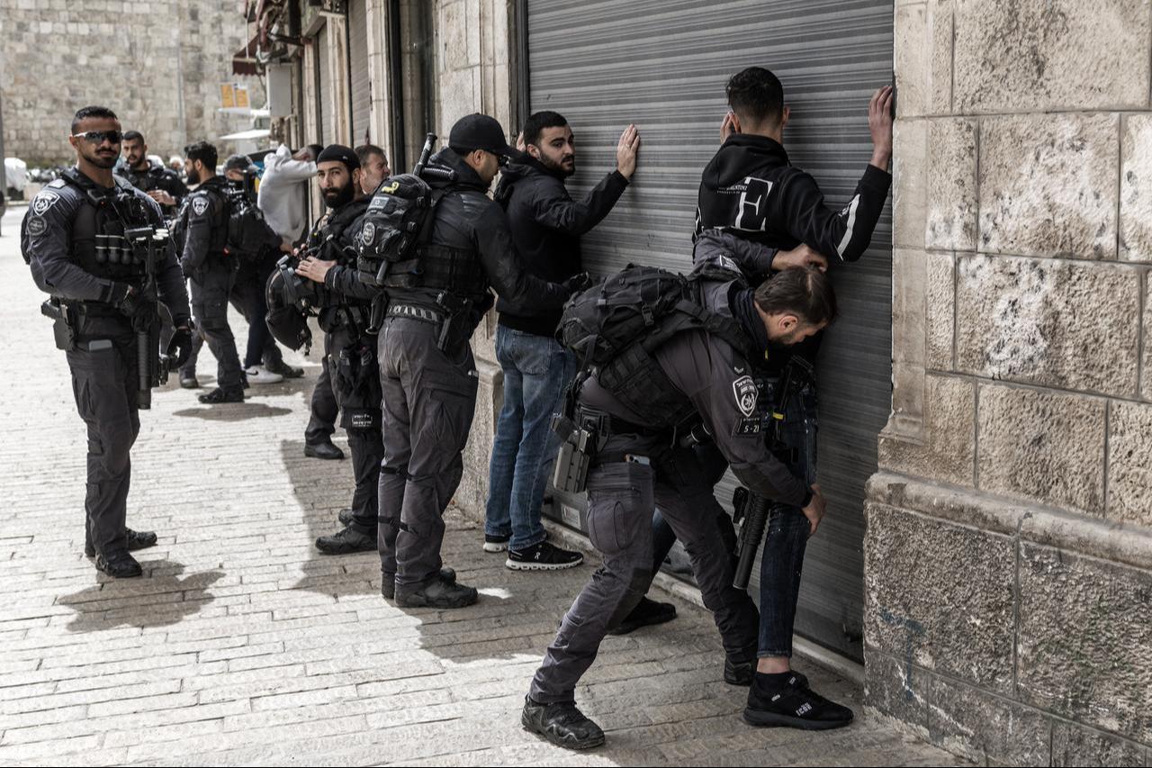 Israeli policemen frisk Palestinian men against shuttered shops ahead of the weekly Muslim Friday noon prayers outside Herod’s Gate in the old city of Jerusalem, April 3, 2026. (AFP Photo)