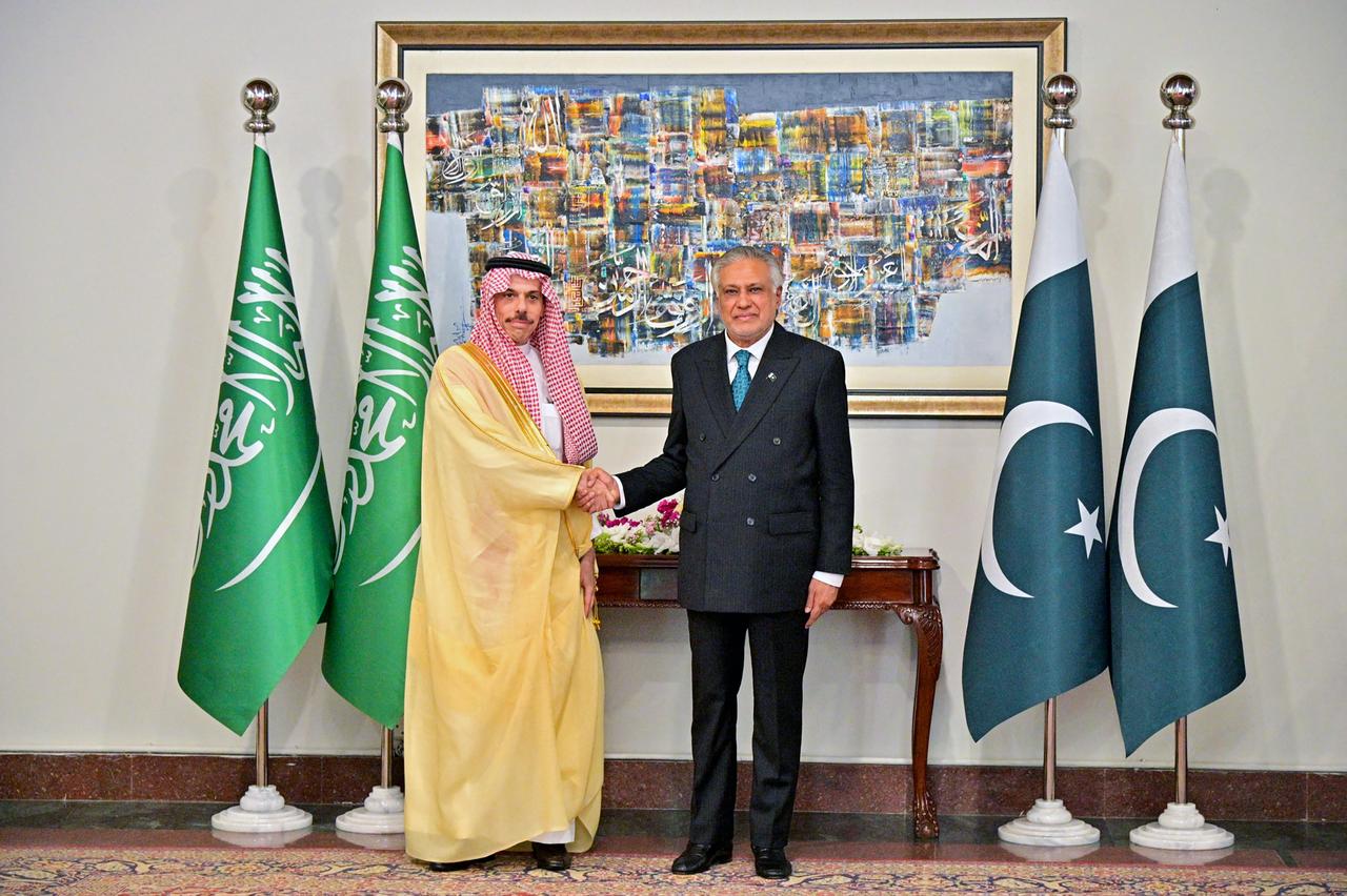 This handout photograph taken on March 29, 2026 shows Pakistan's Foreign Minister Ishaq Dar (R) shaking hands with his Saudi Arabian counterpart Faisal bin Farhan in Islamabad. (Photo by Pakistan Foreign Ministry/AFP)